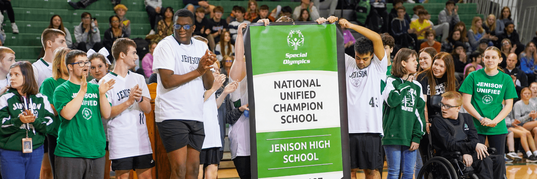 photo of unified sports students holding their new banner