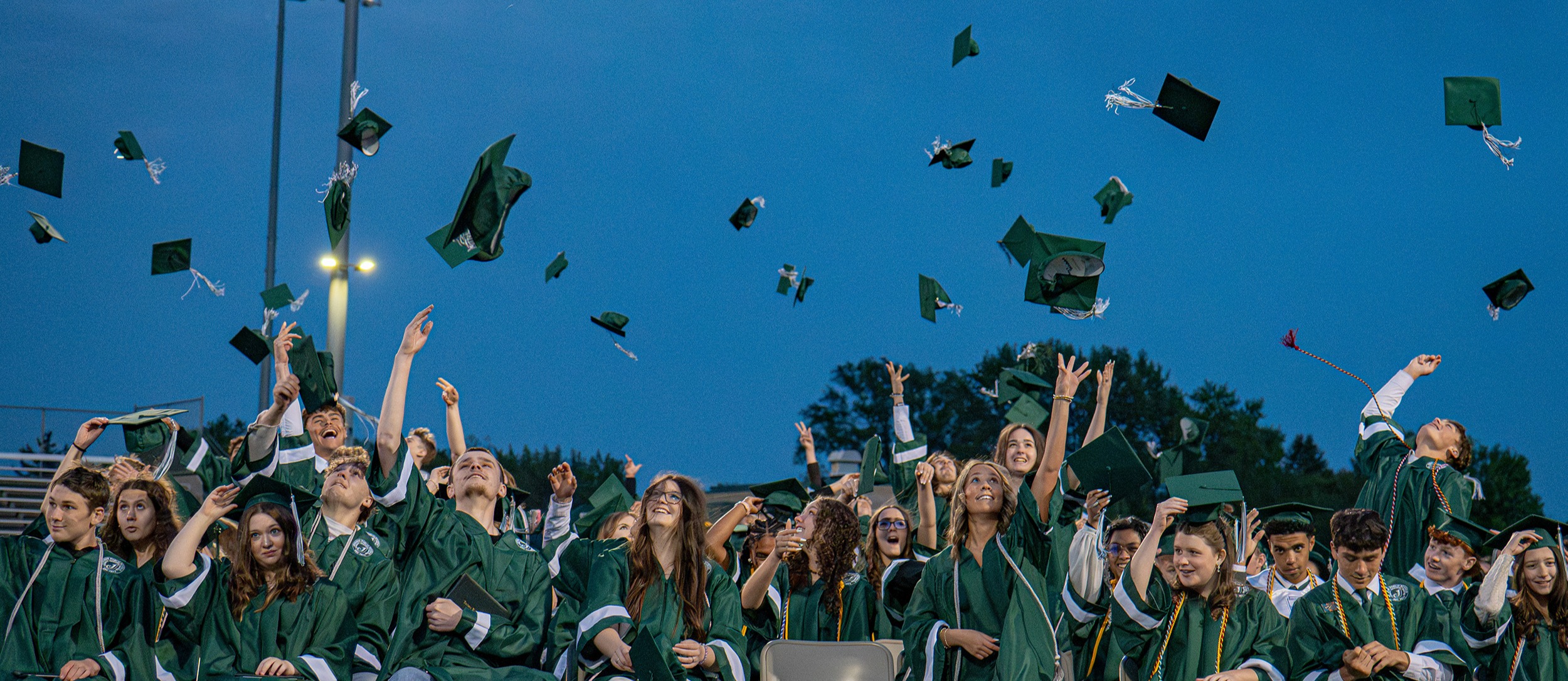 Graduates throwing their caps in the air
