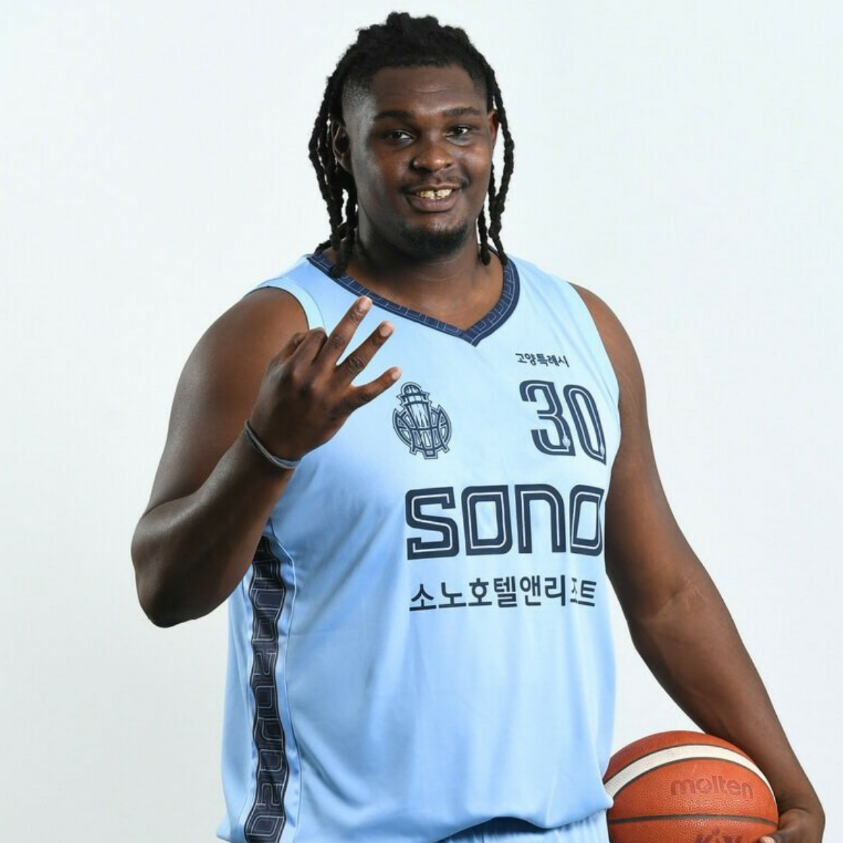 Man in light blue basketball uniform, number 30, holding a basketball, smiling, and waving.
