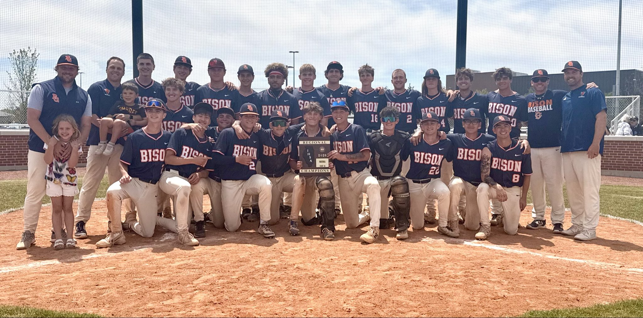BGHS Bison Baseball team on the field with the Regional Championship plaque