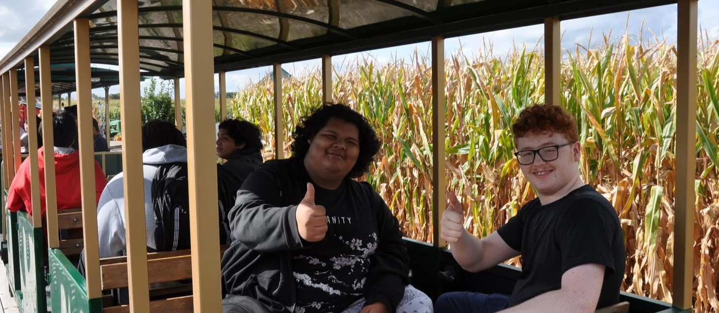 Academy students thumbs up in corn maze