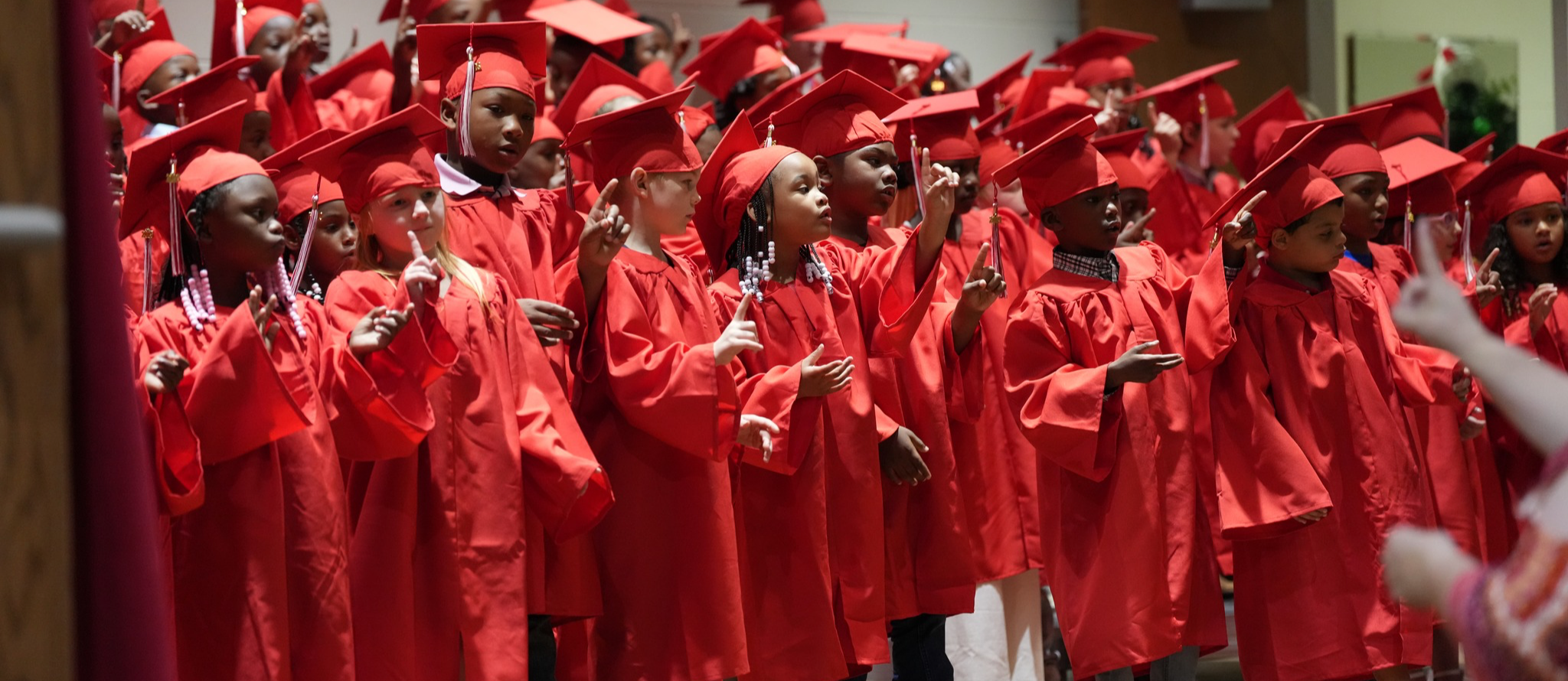 Kindergarten graduates singing on stage
