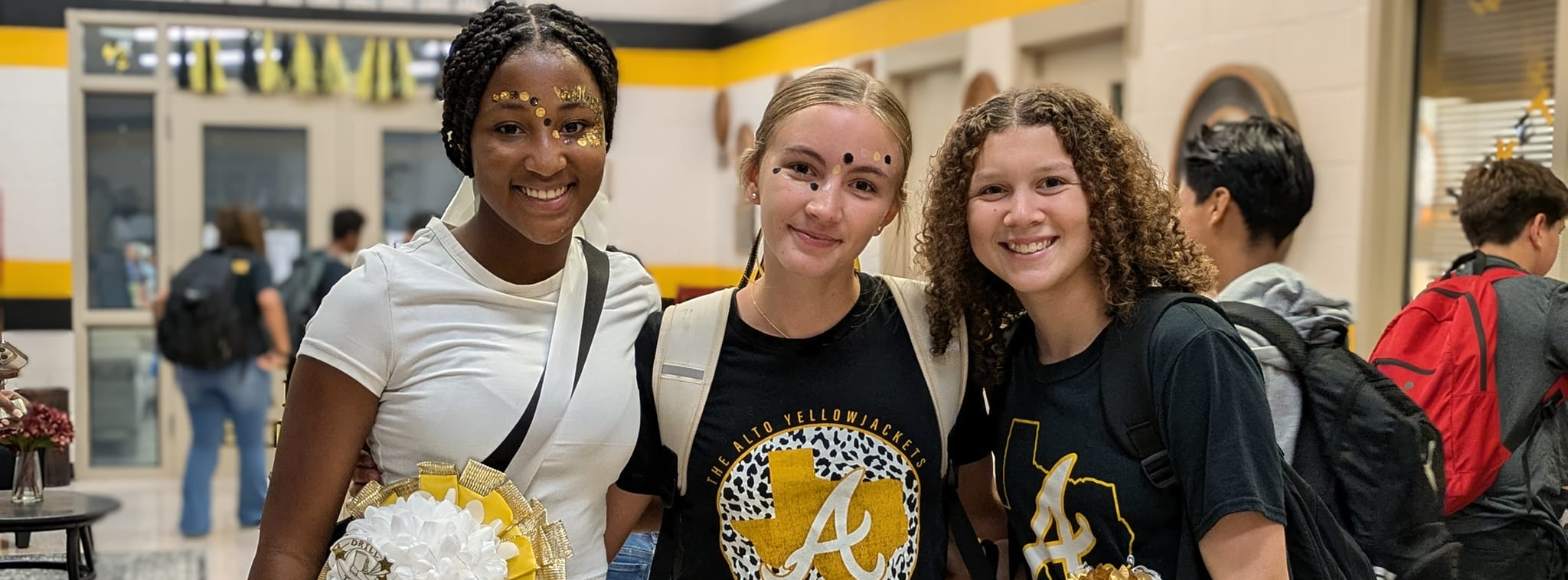 Three middle school students with homecoming mums