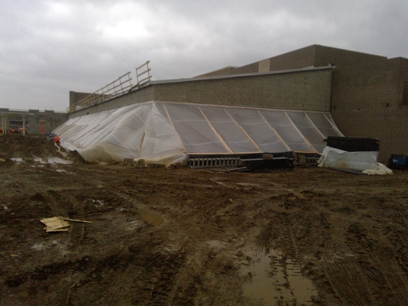 Photo of the School administrative offices tented in to do blockwork.