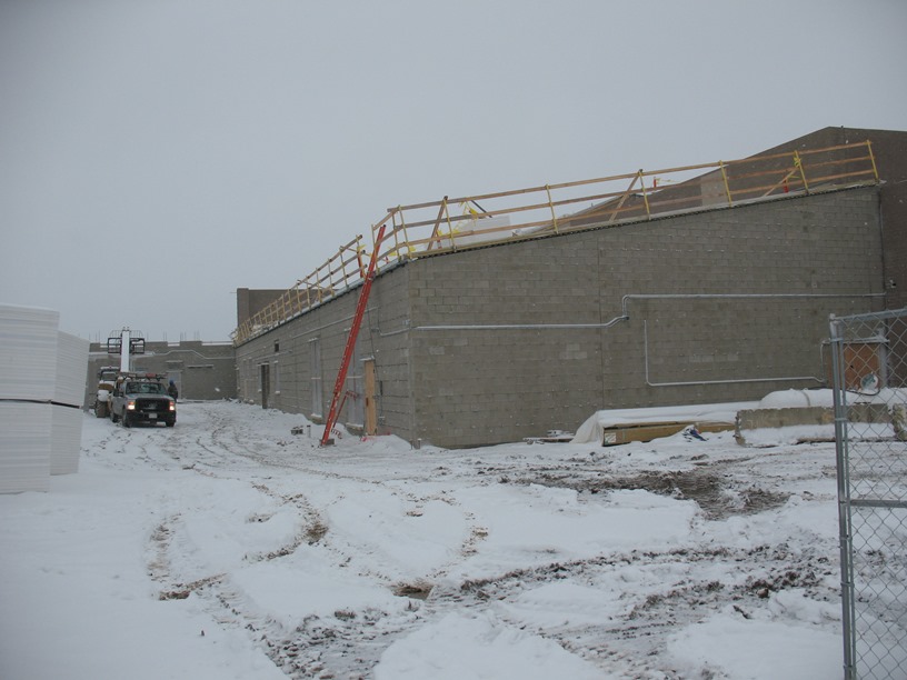 Photo of the Roof being installed over the band room, media center, and family and consumer science classrooms.