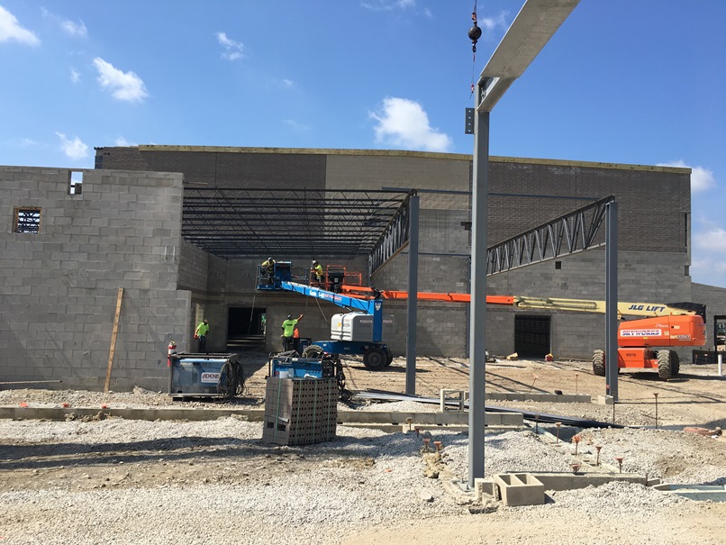 Photo of the Girder set over the new cafeteria in front of the new gym.