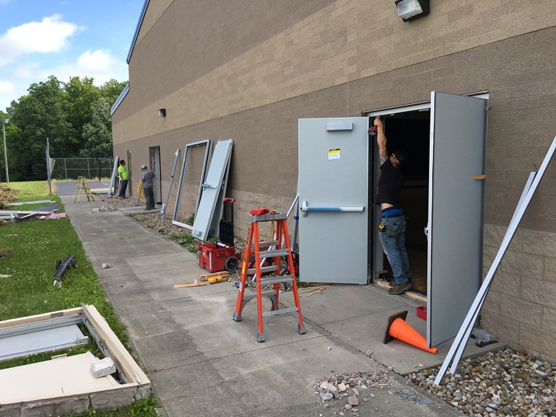 Photo of the Installation of new exterior doors at the back of the elementary school gym.