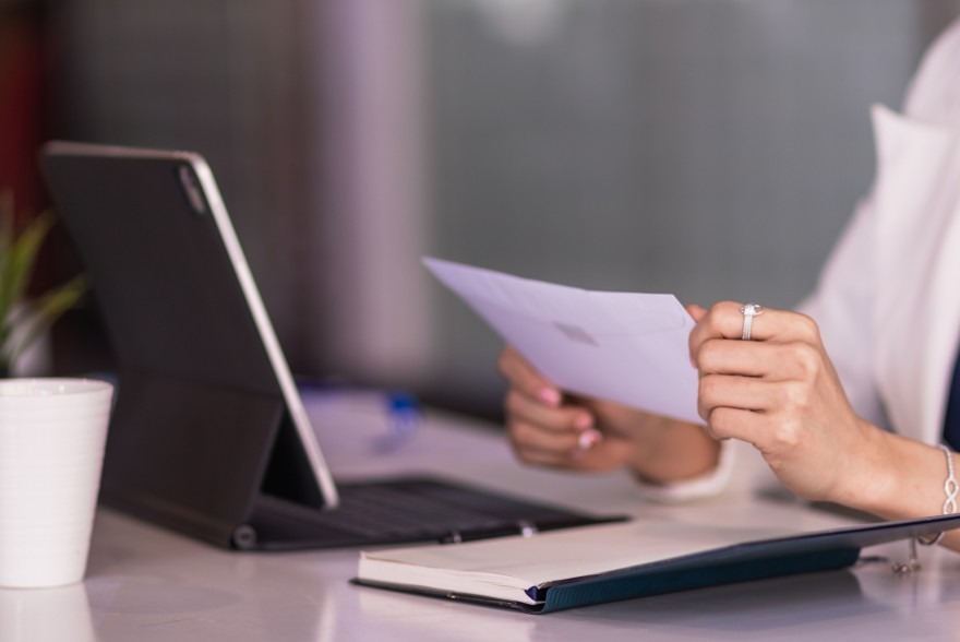 Person sitteing at a computer with a letter