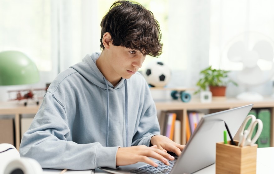 student sitting at a computer taking a test