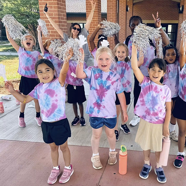 Student celebrate holding pom poms