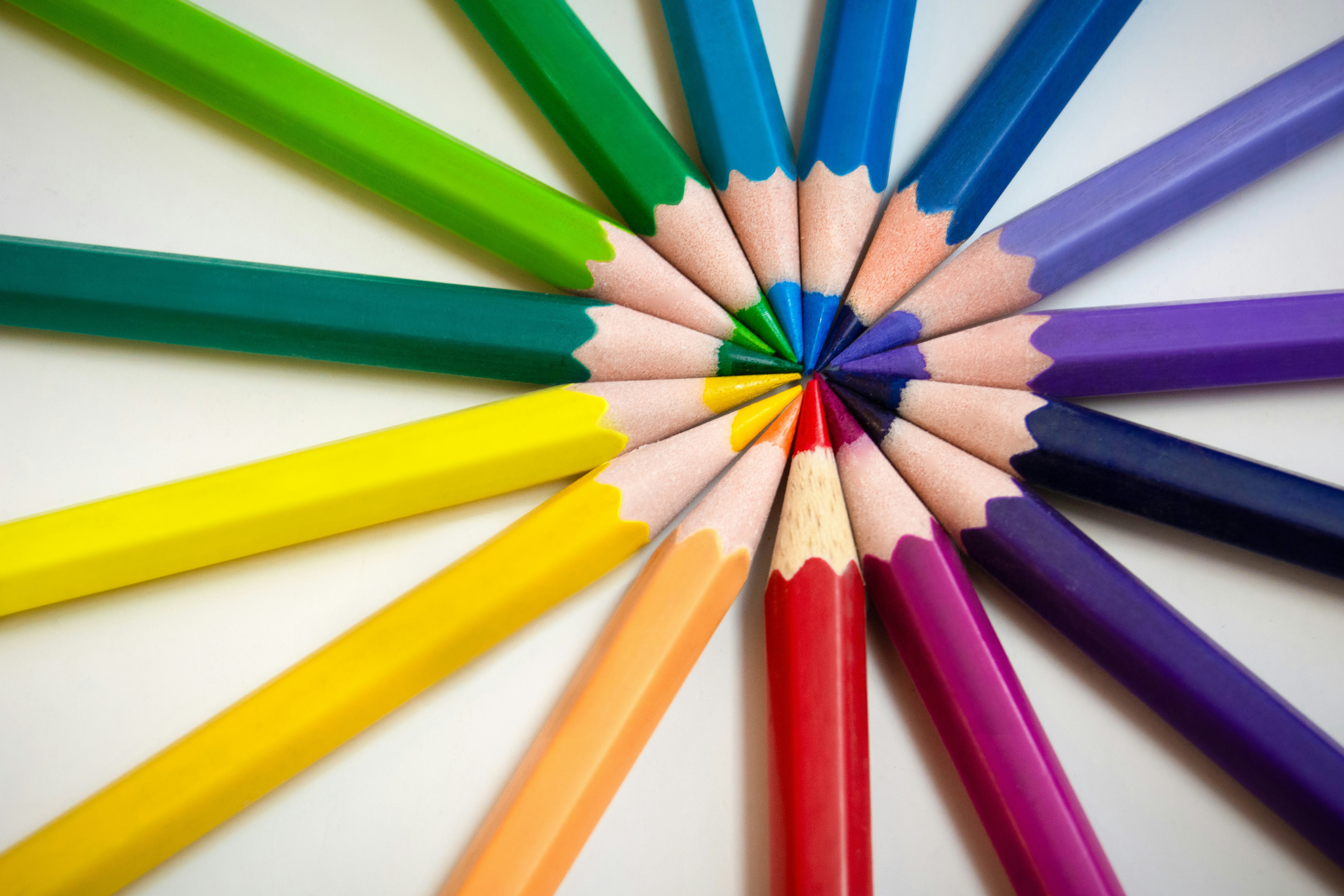 Colored pencils aligned in a rainbow