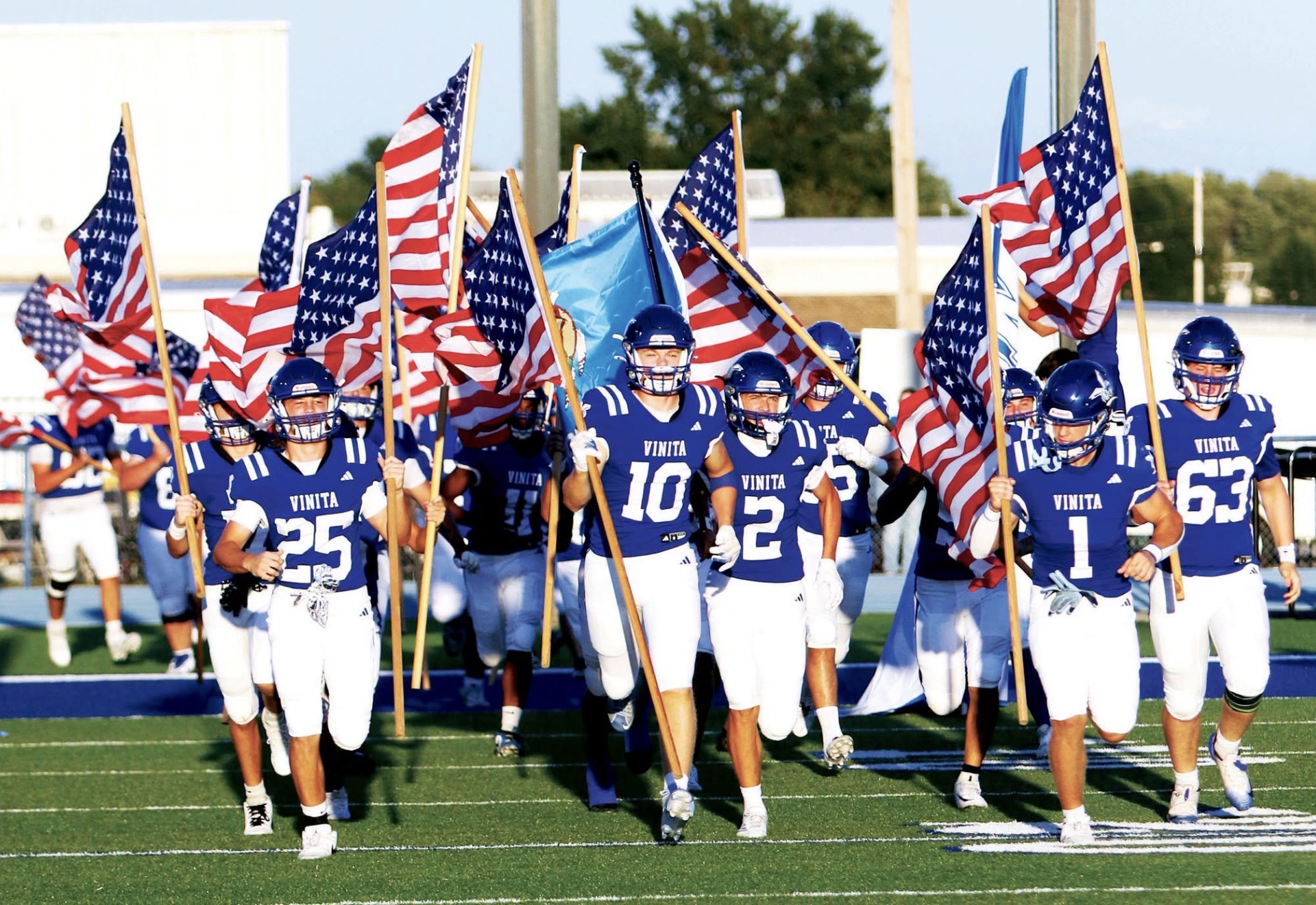 football team enters with flags