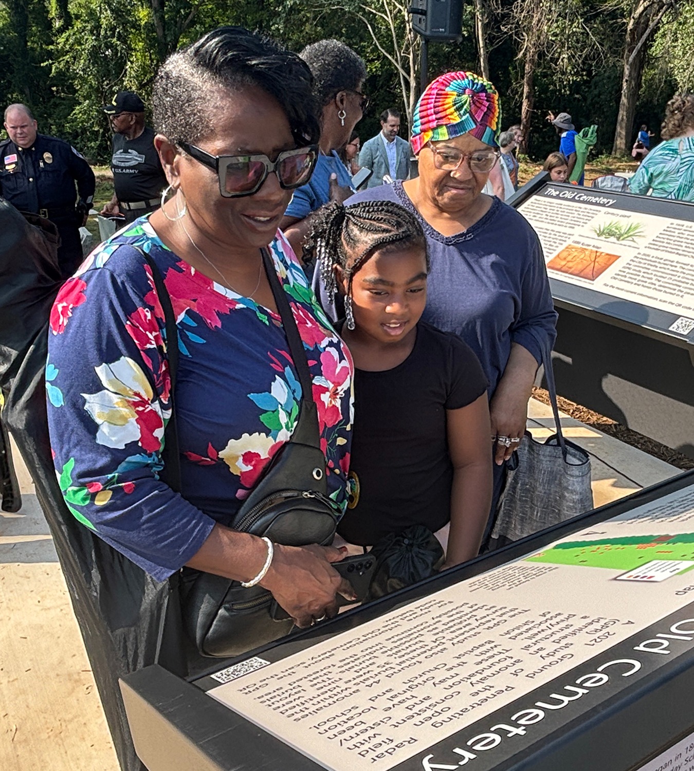 People looking at the markers at the Old Cemetery