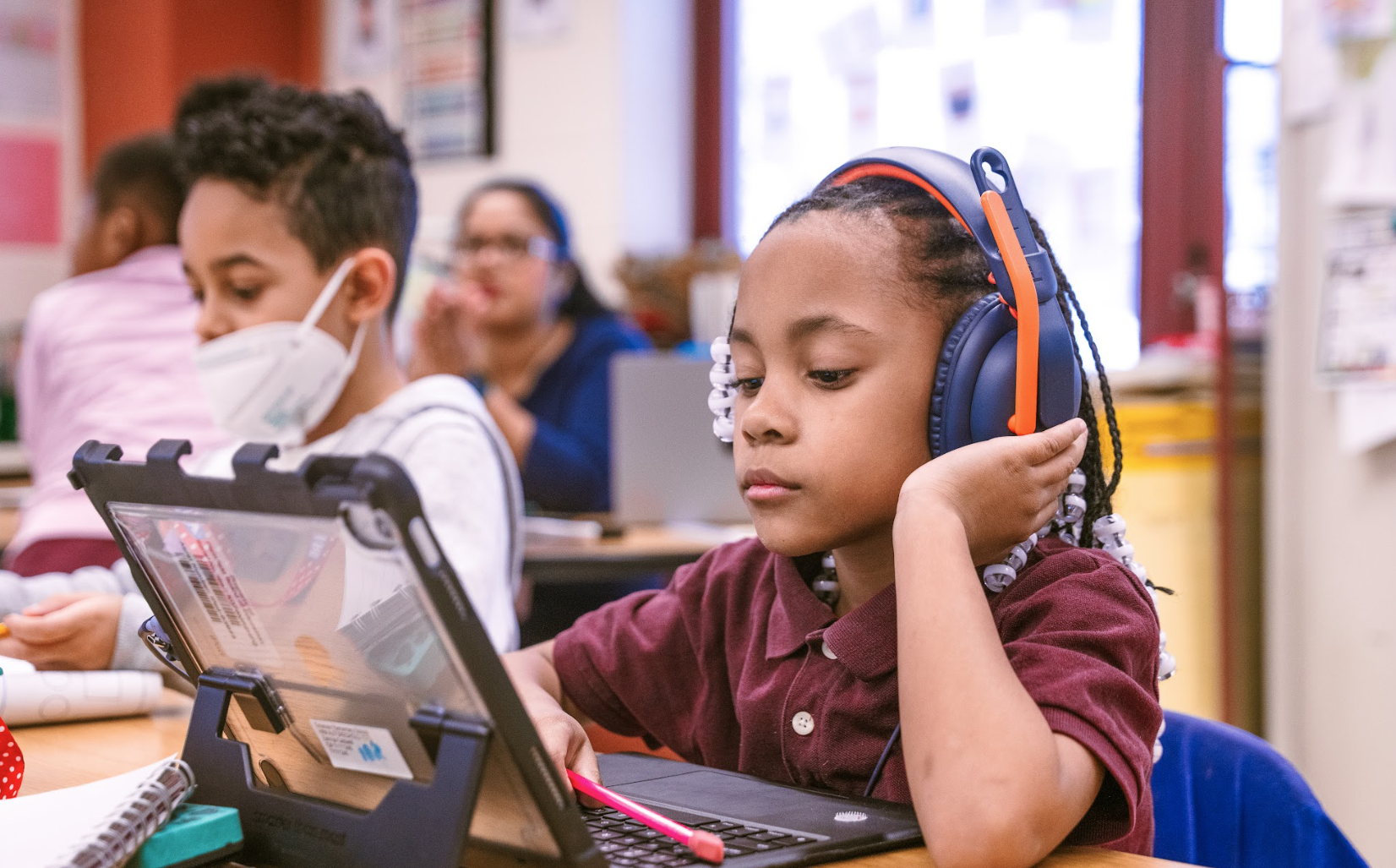 Student with headphones and tablet