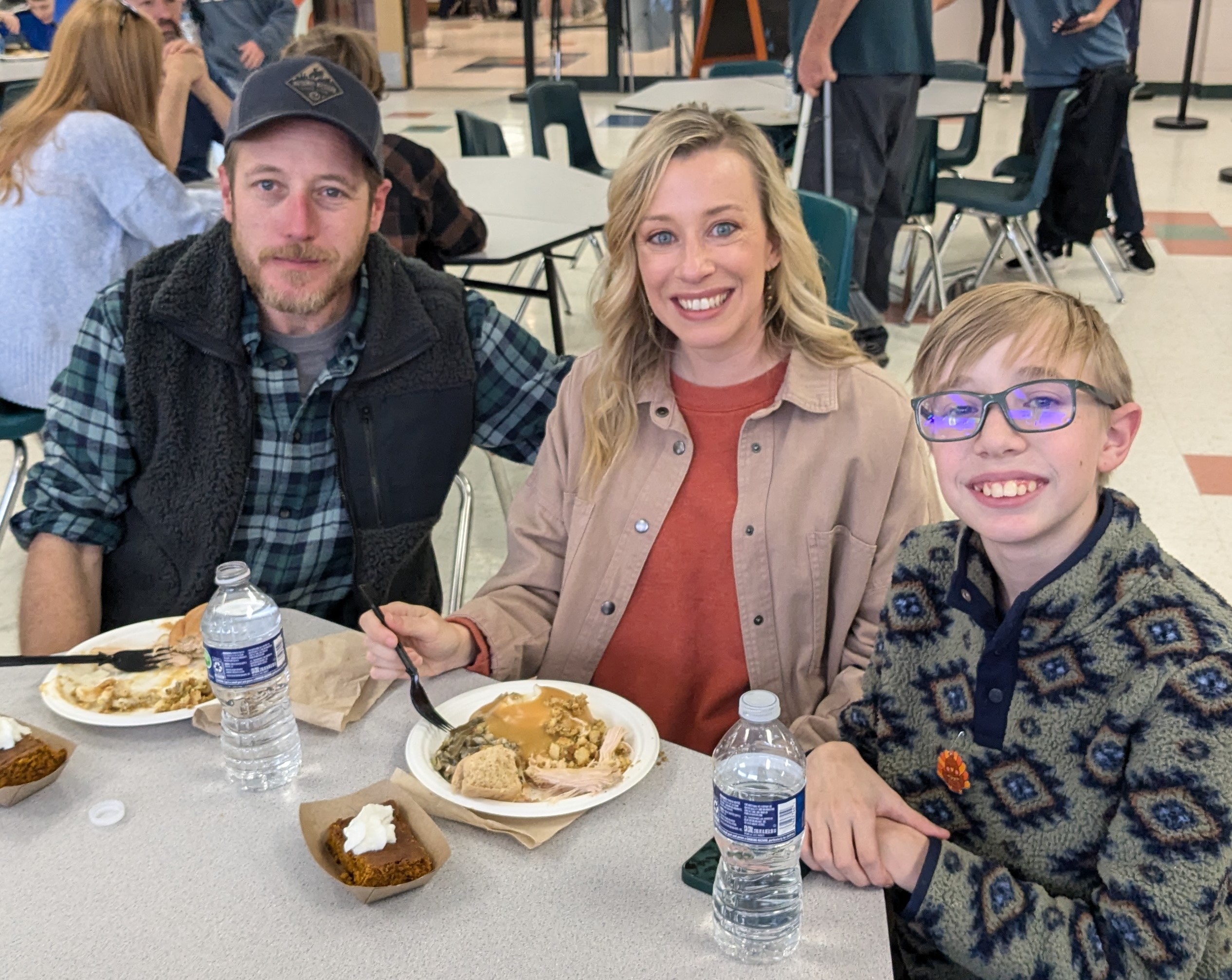 A family and their student posing at lunch