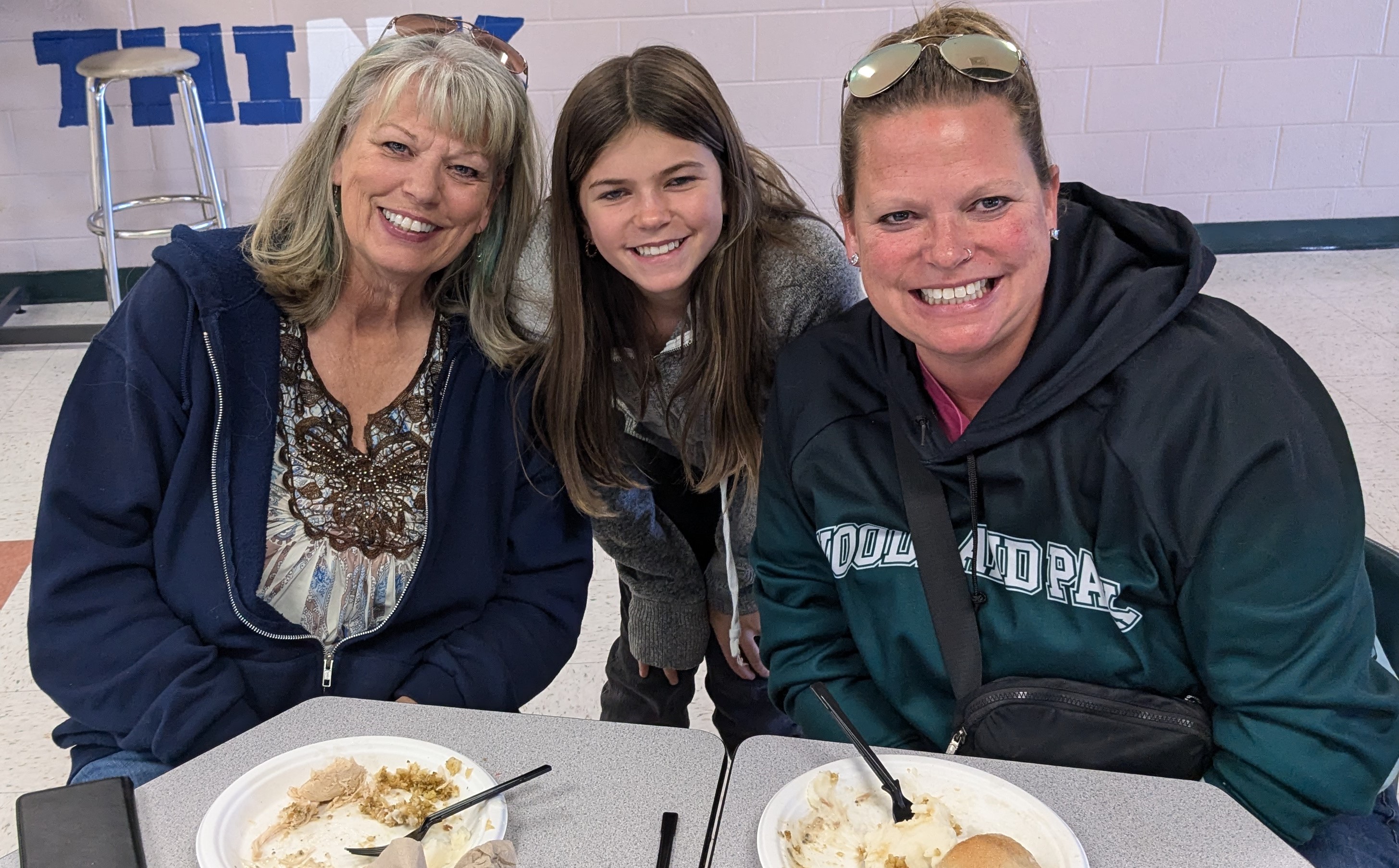 A family and their student posing at lunch