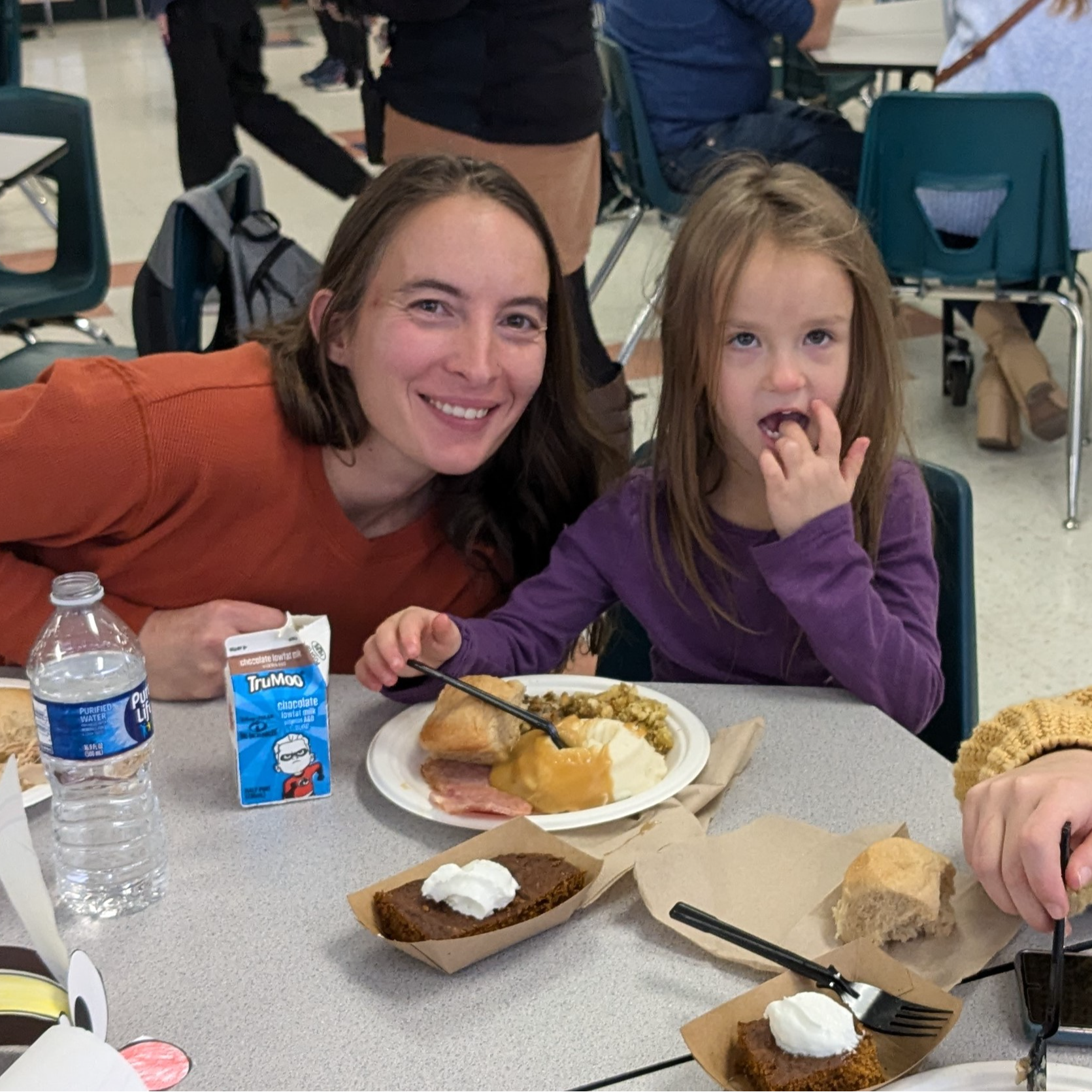 A family and their student posing at lunch