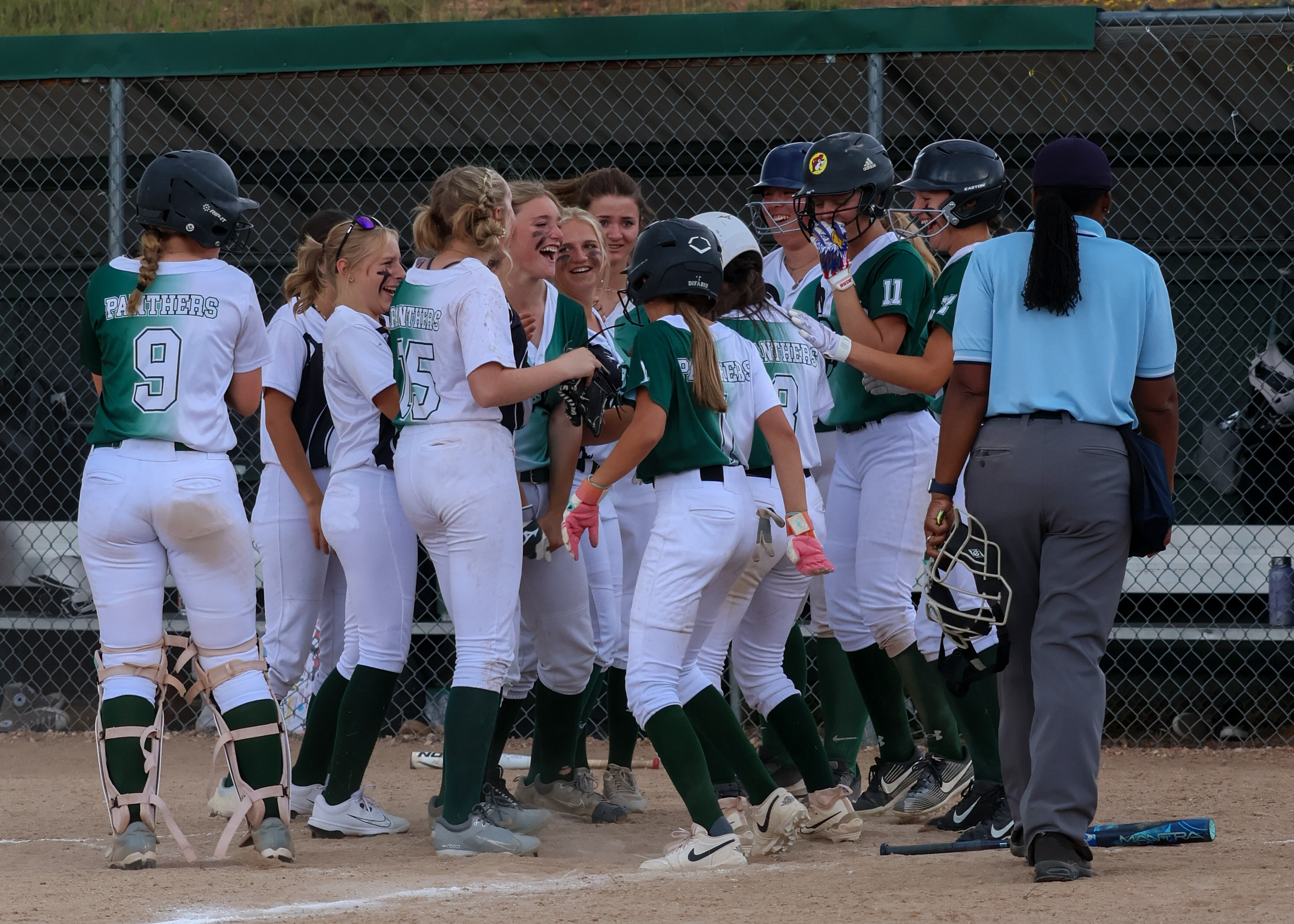 Softballs players congratulating each other after a win