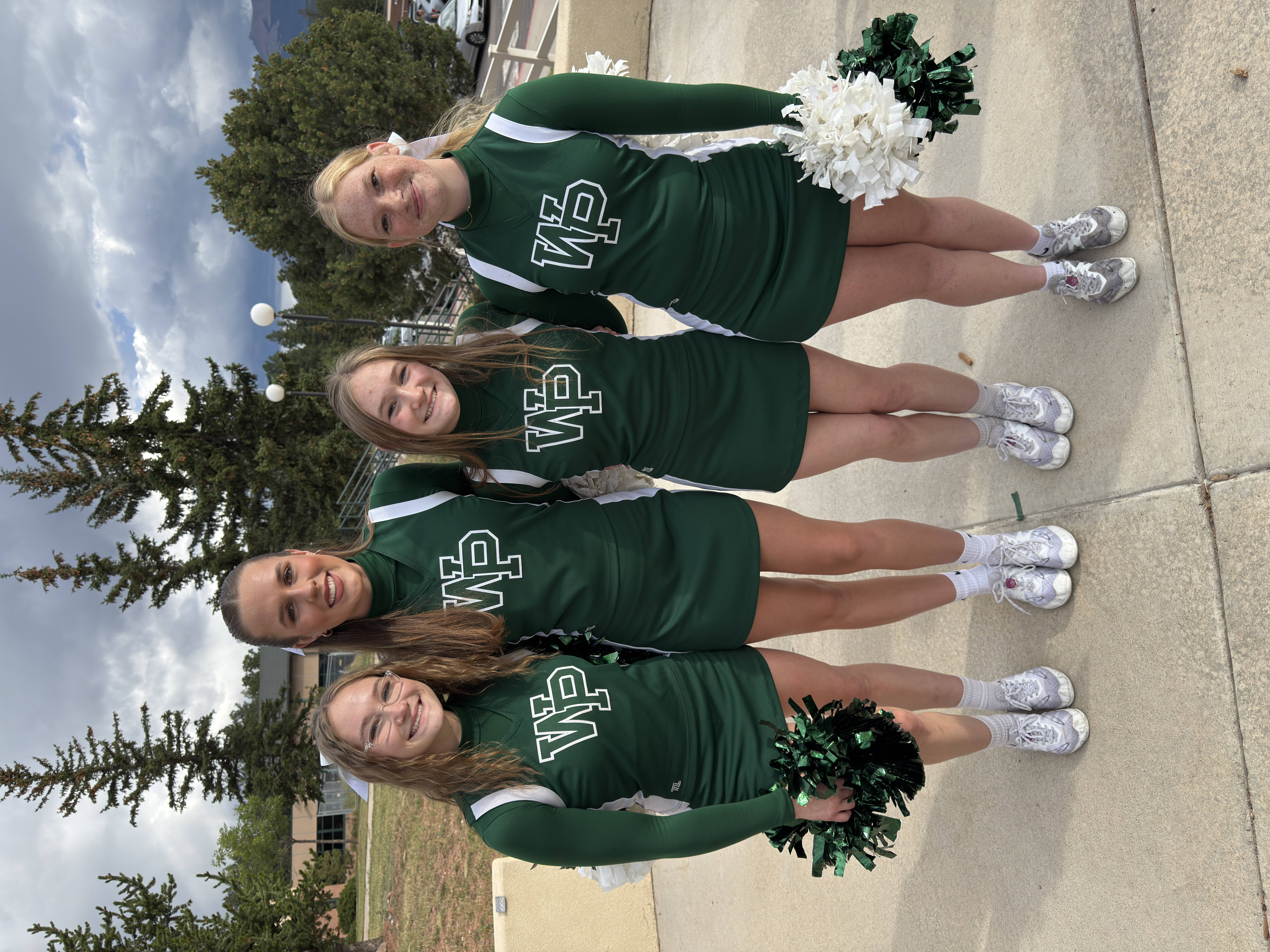 Four cheerleaders posting for a photo