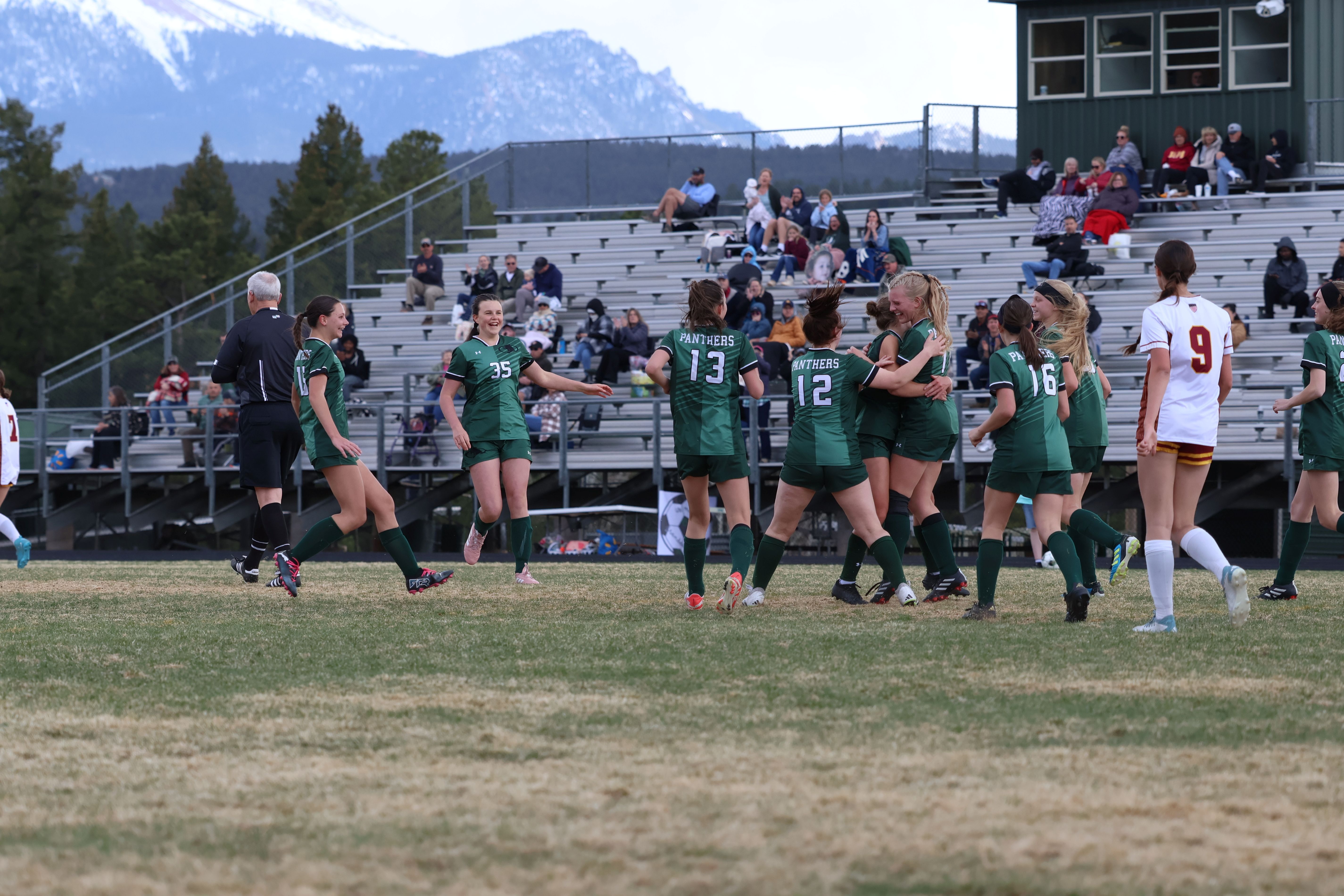 Girls soccer team members on the field during a match