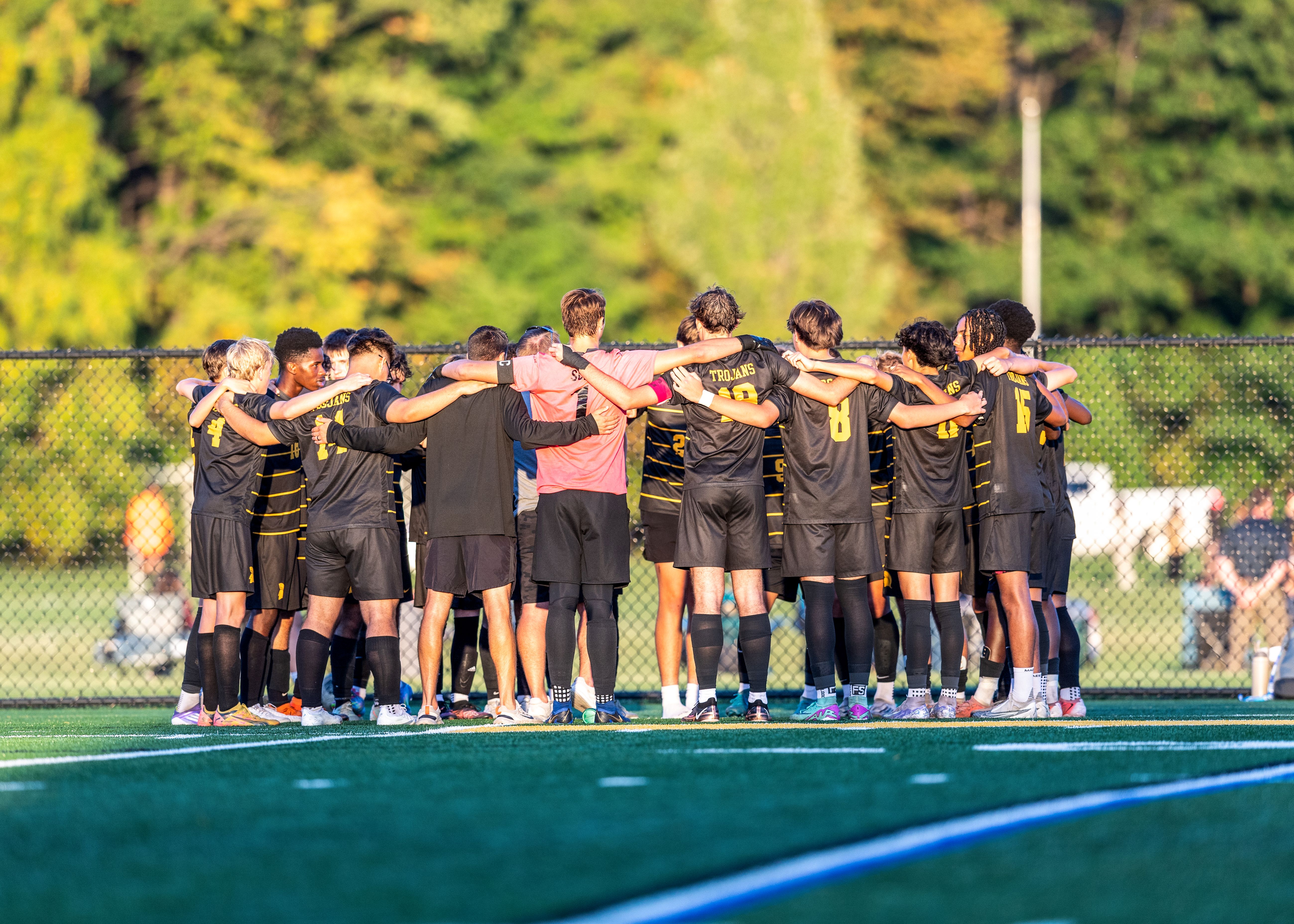 Boys huddle up during soccer game