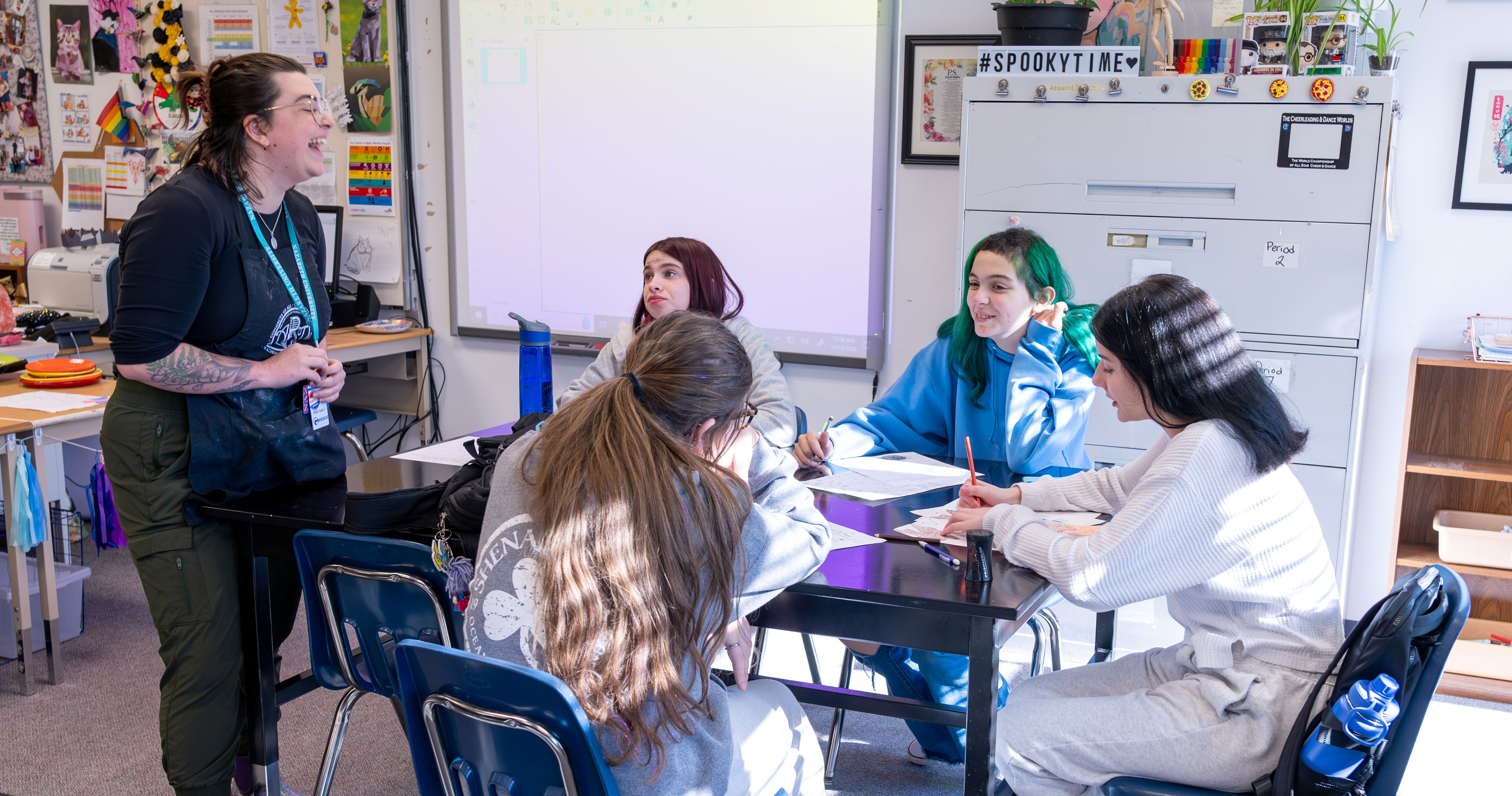 Teacher laughing with students