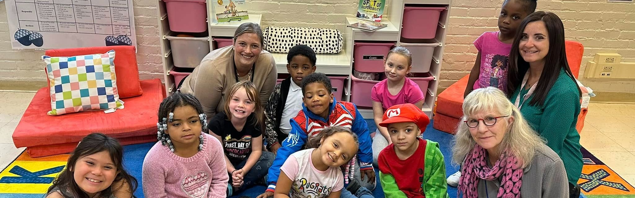 Students and adults smiling. 