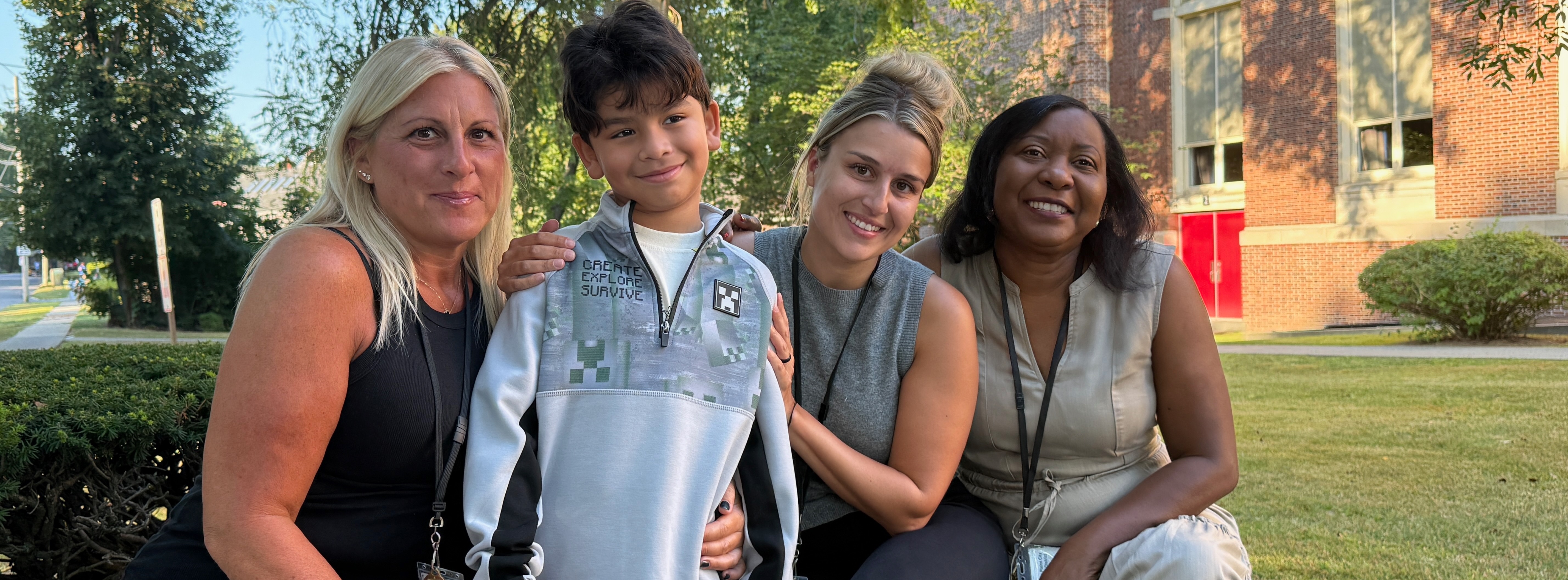 teachers and students on a bench