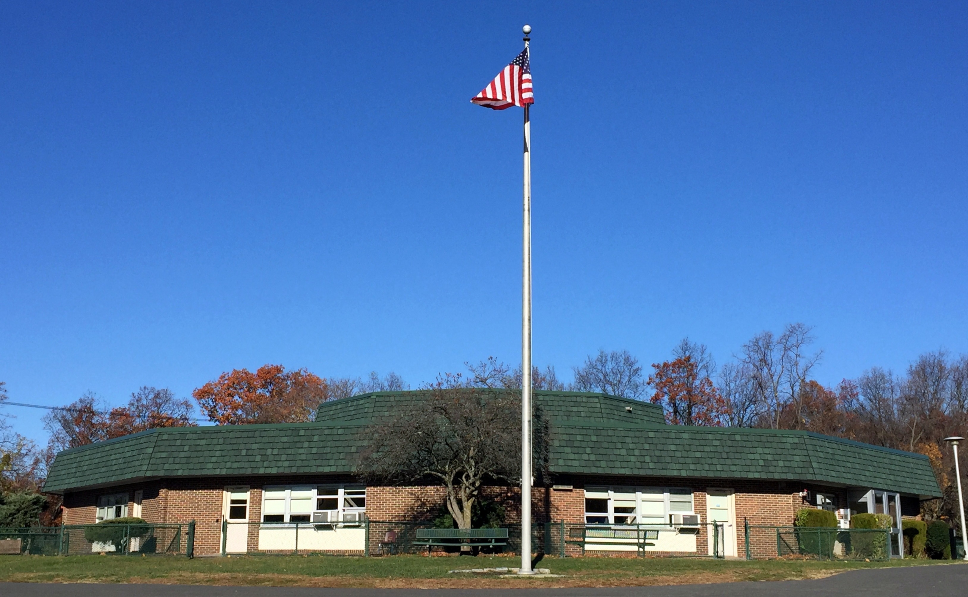 A decagonal-shaped building with a flag flying out front