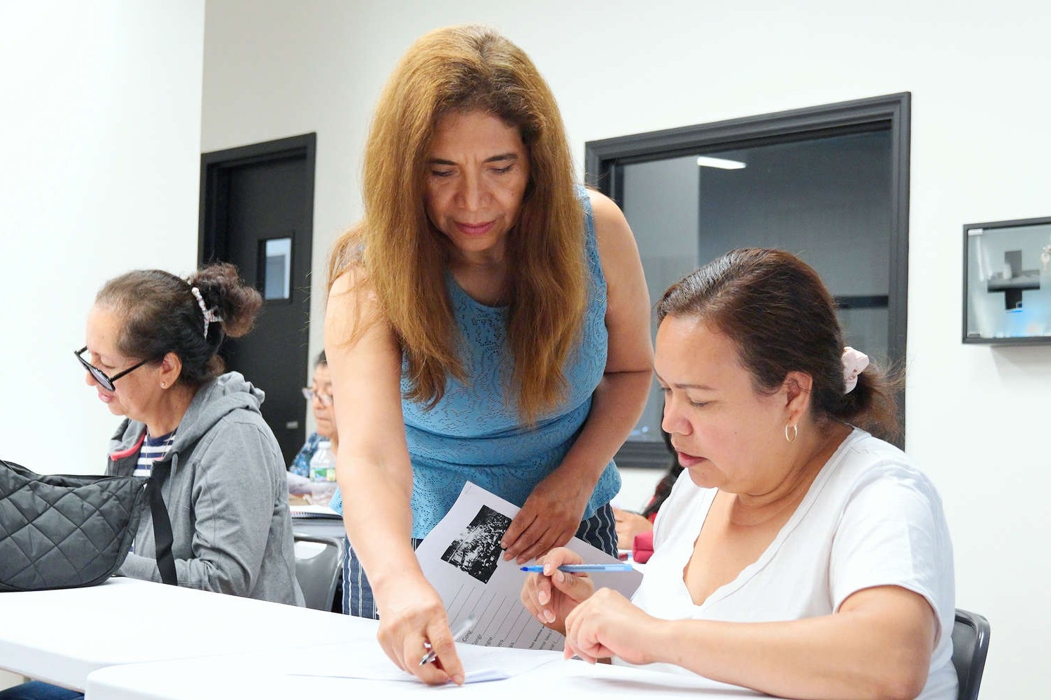 teacher assists students in a classroom
