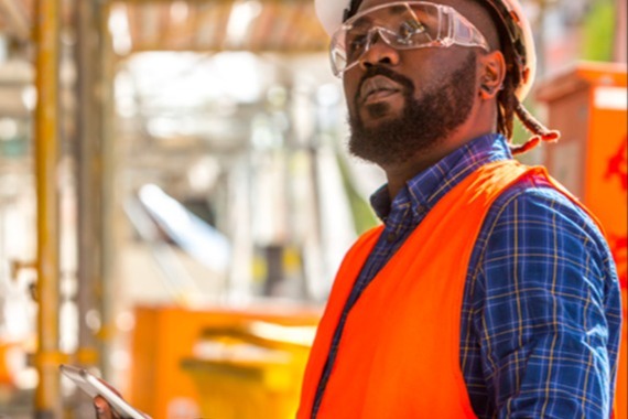 man in hardhat and safety glasses on job site