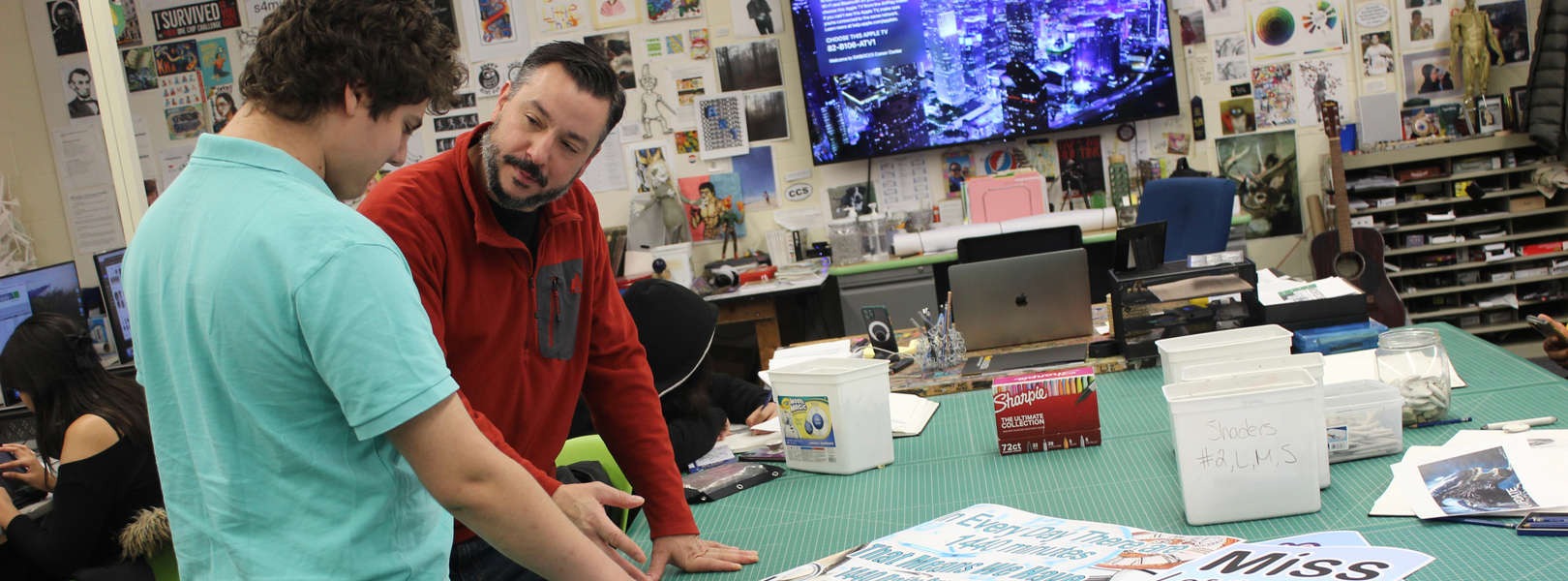 teacher assists student