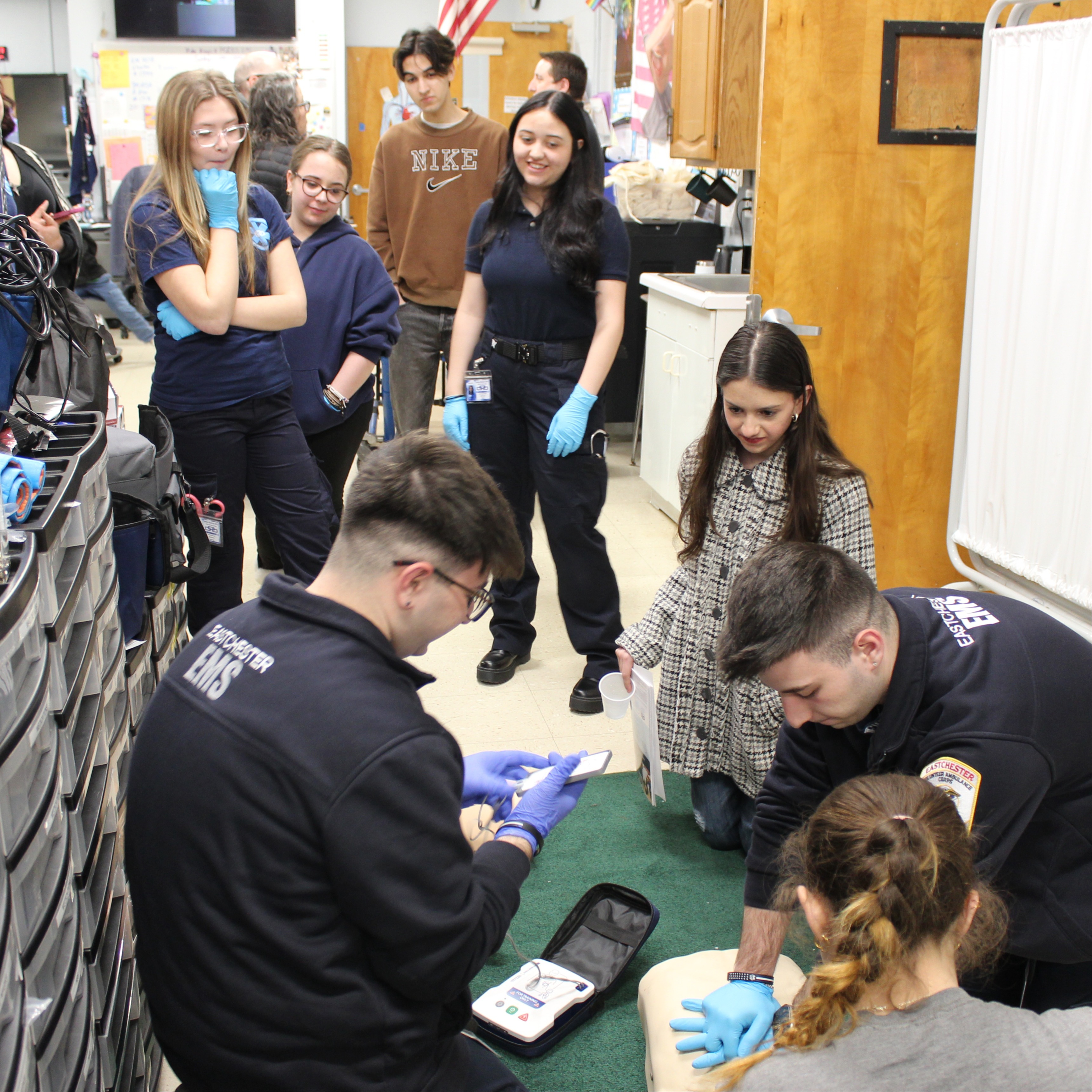 EMS students look on as classmates practice CPR