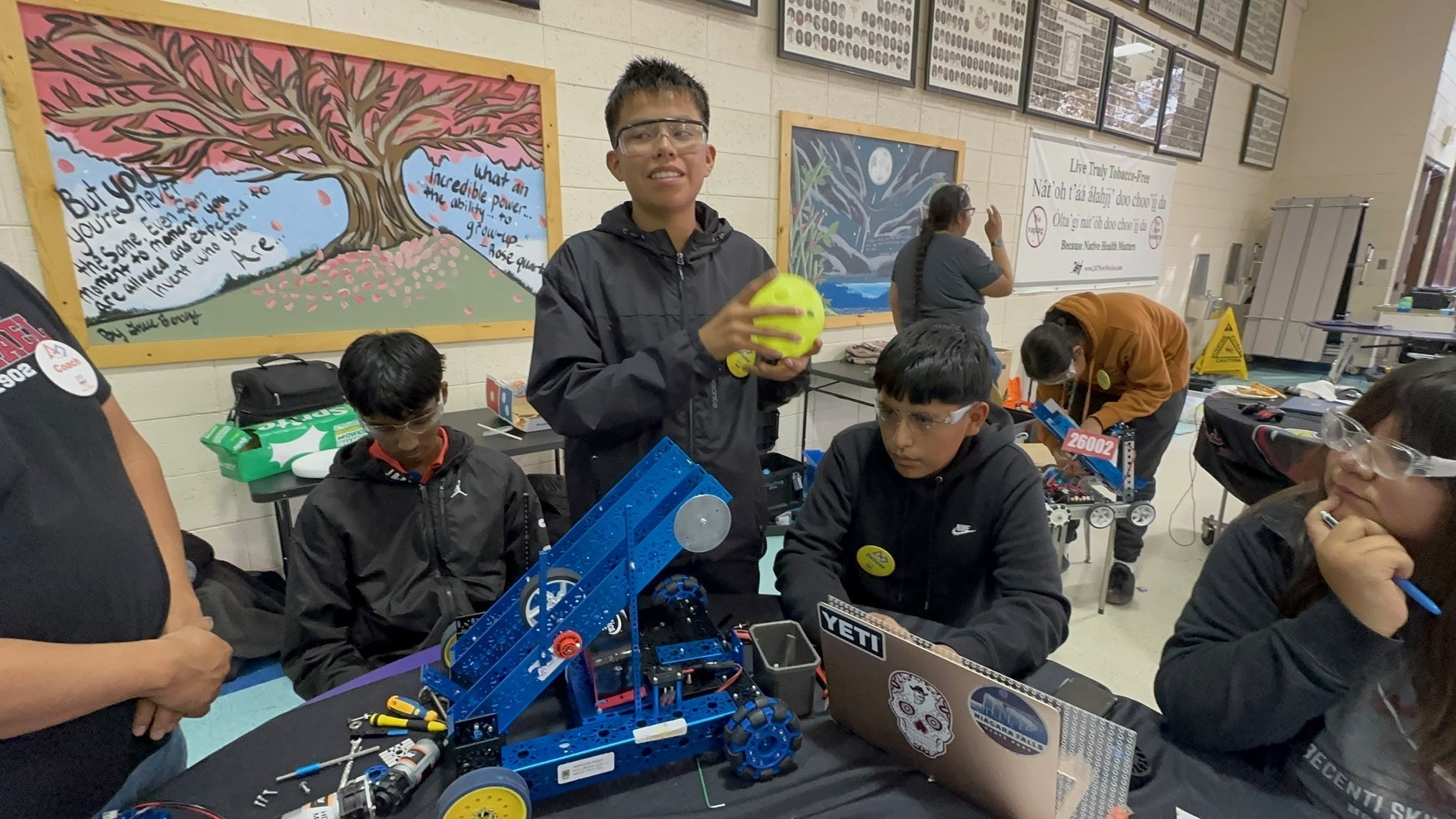 Students show off model robot on table