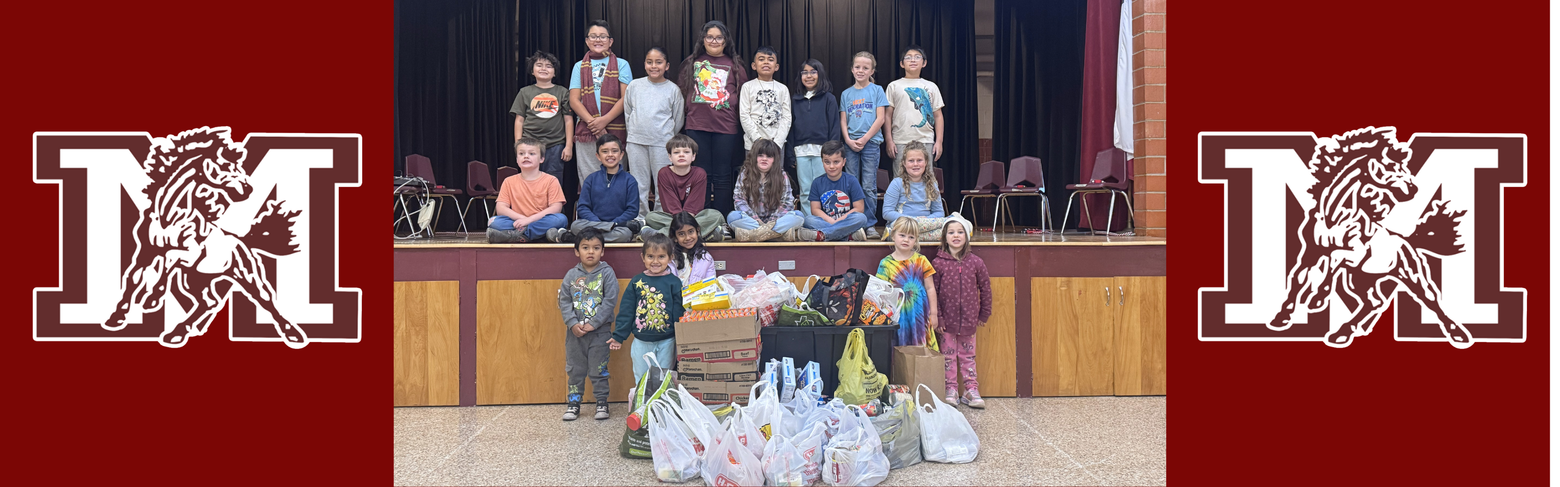 students posing with food for food drive.