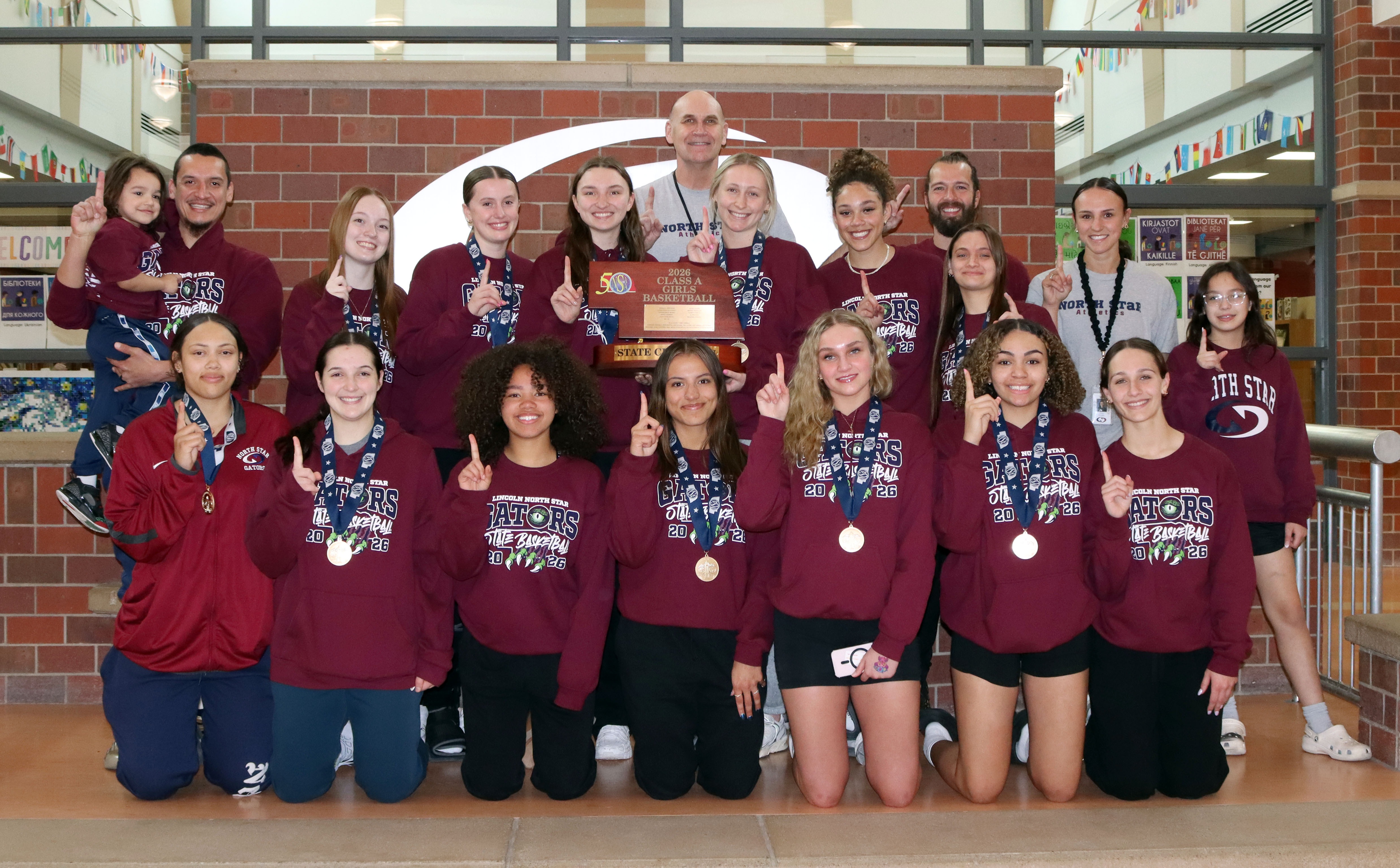 North Star girls state basketball champions in a group holding the trophy.