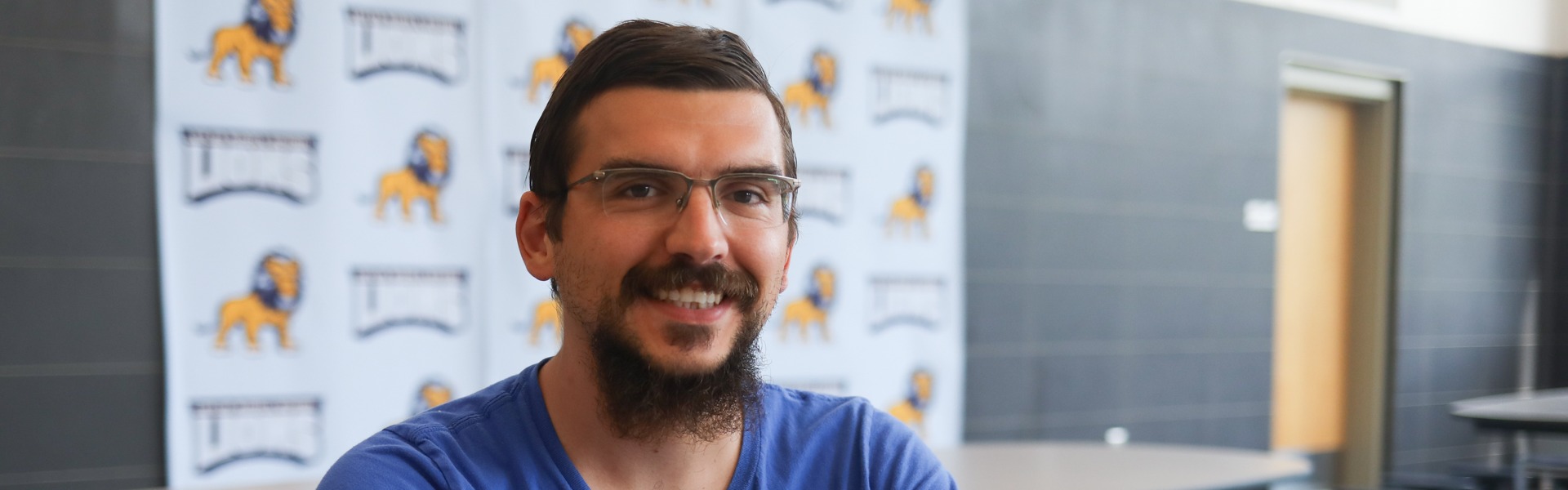 Man sitting at the table with a smile. 
