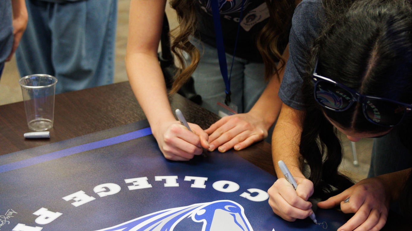 Students signing the Shepherd College Prep banner