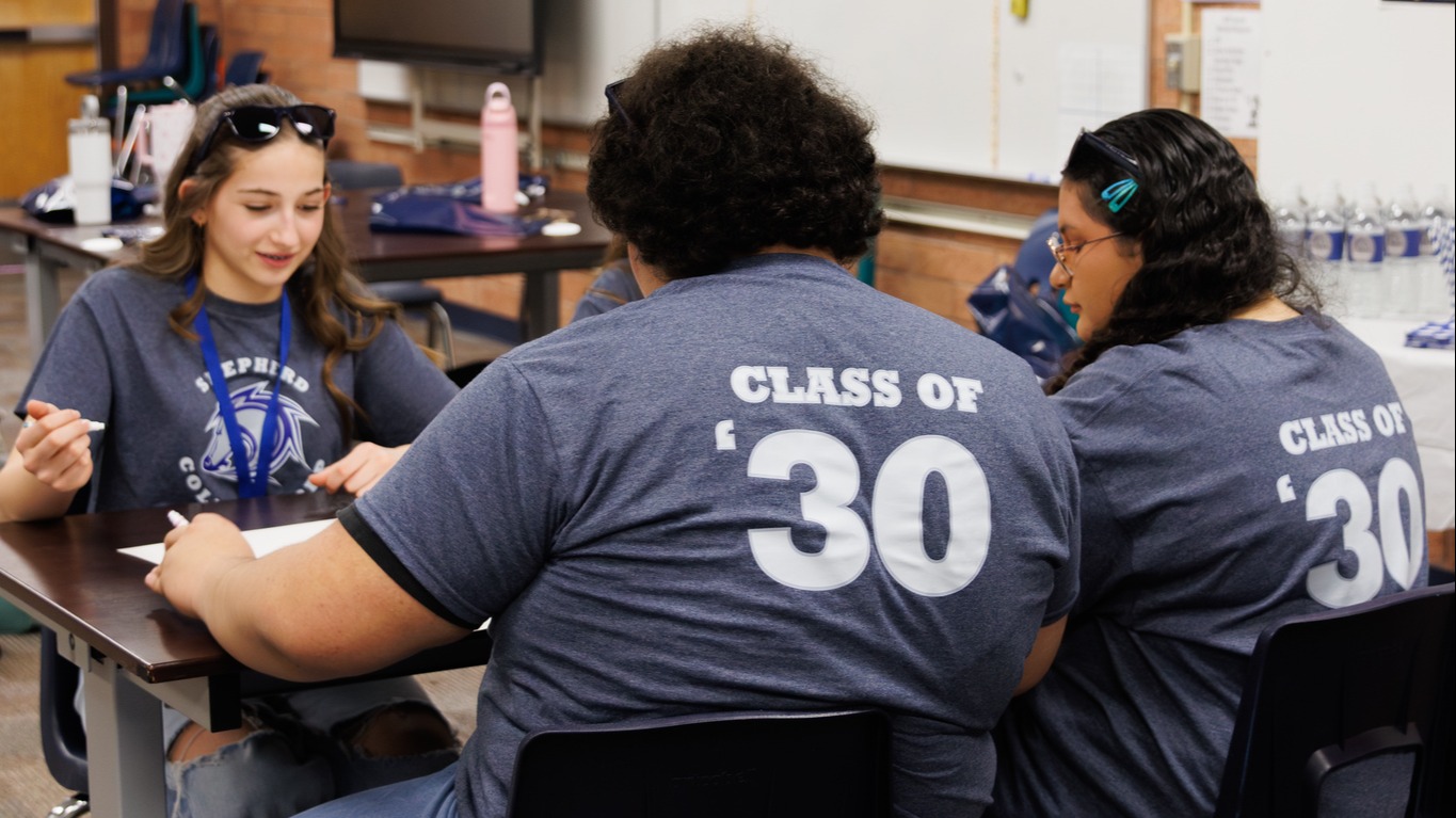 Three Shepherd College Prep students sitting at a table