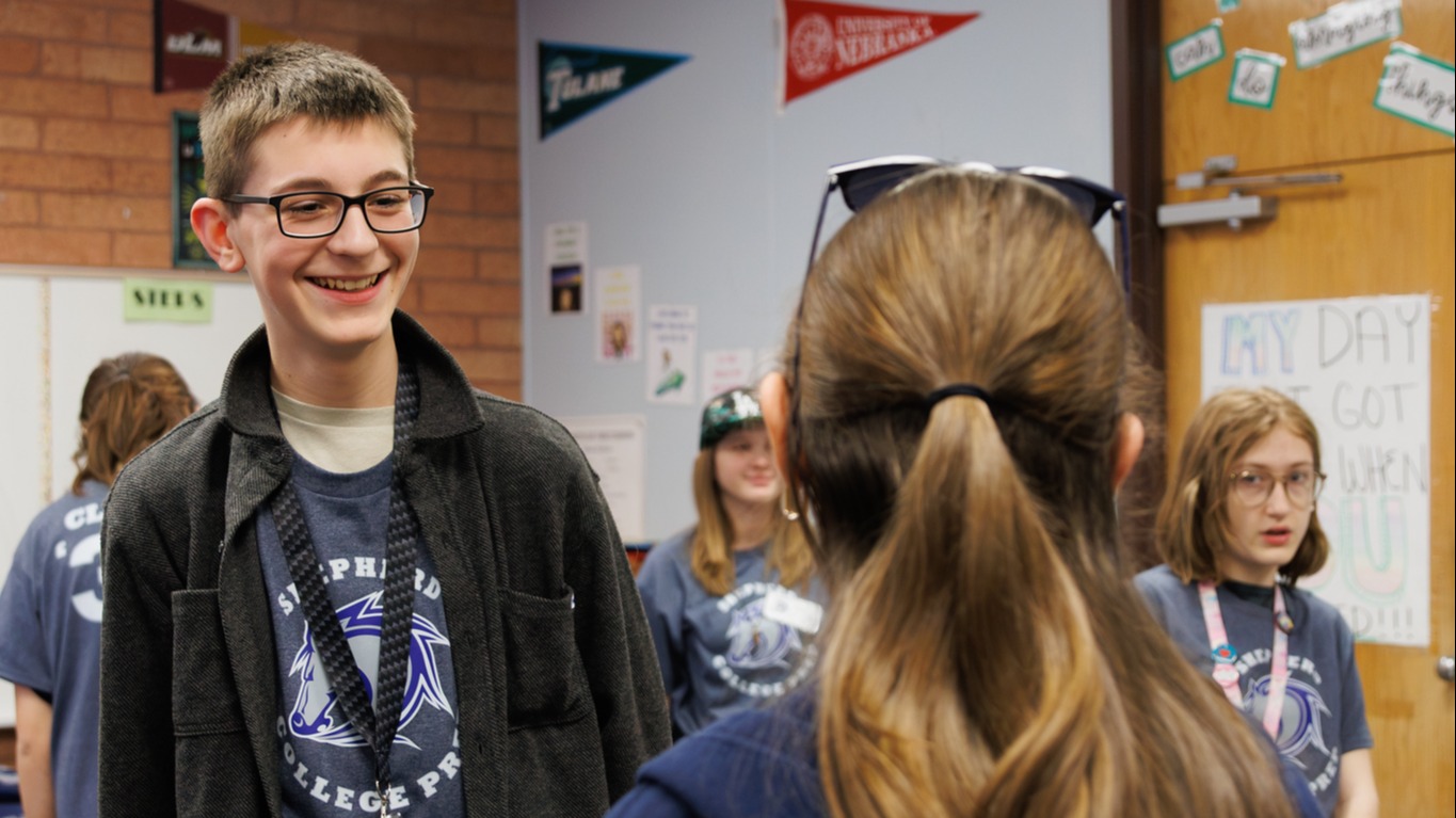 Two Shepherd College Prep students facing each other with three other students in the backgroune