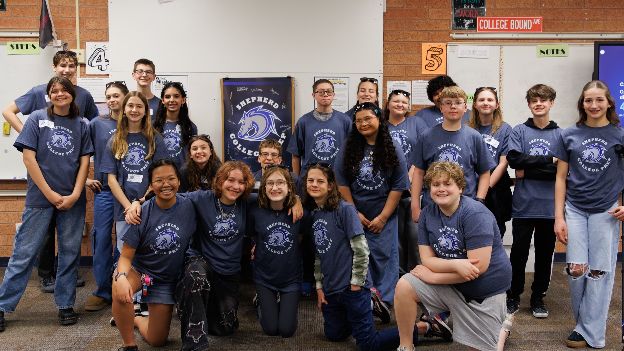 22 Shepherd CP students wearing Shepherd CP t-shirts posing for a picture