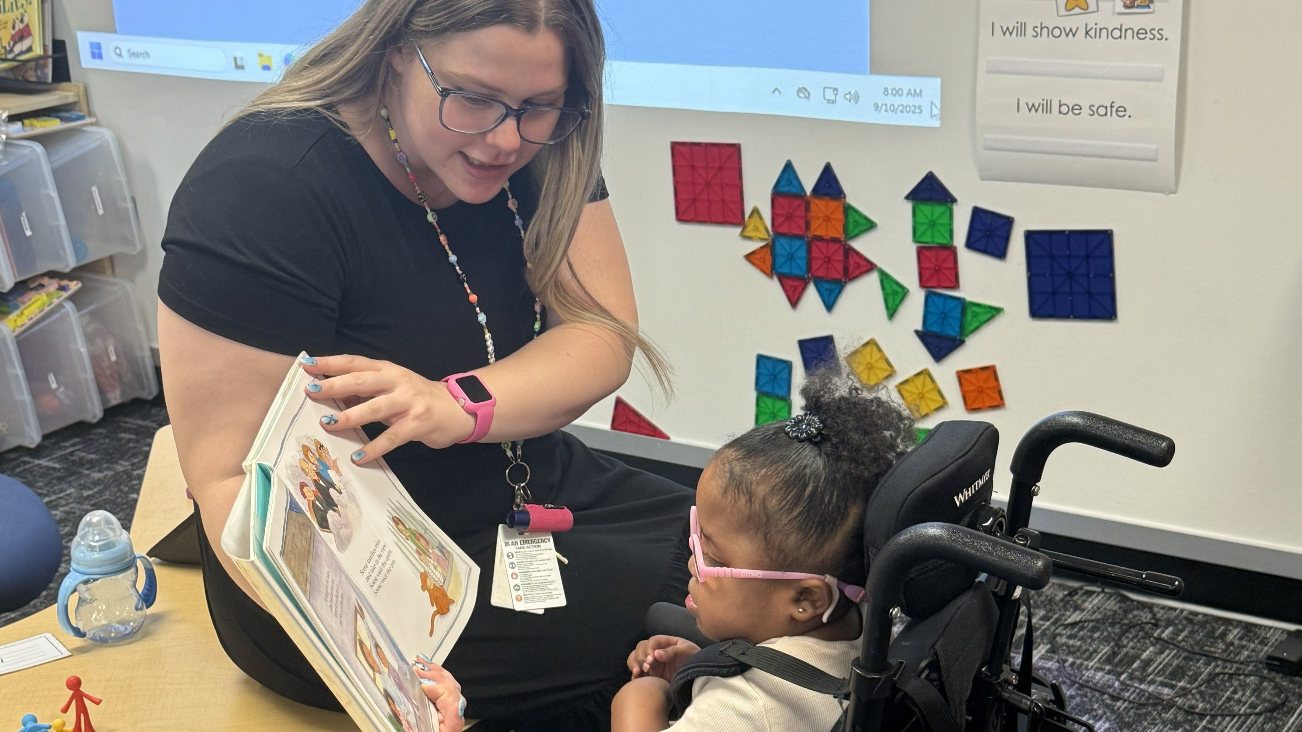 teacher reading accessible text to student