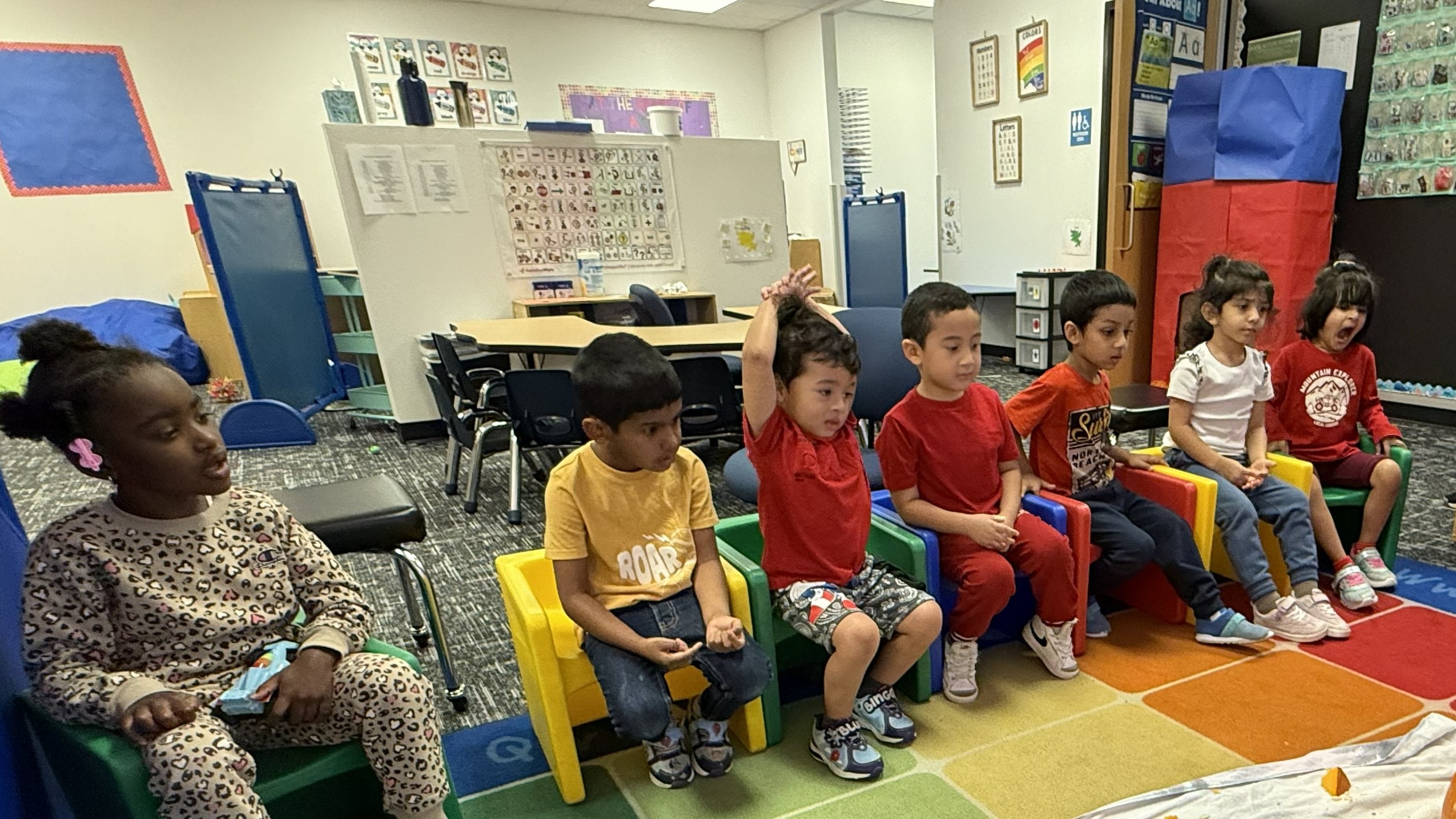 students sitting in chairs watching class