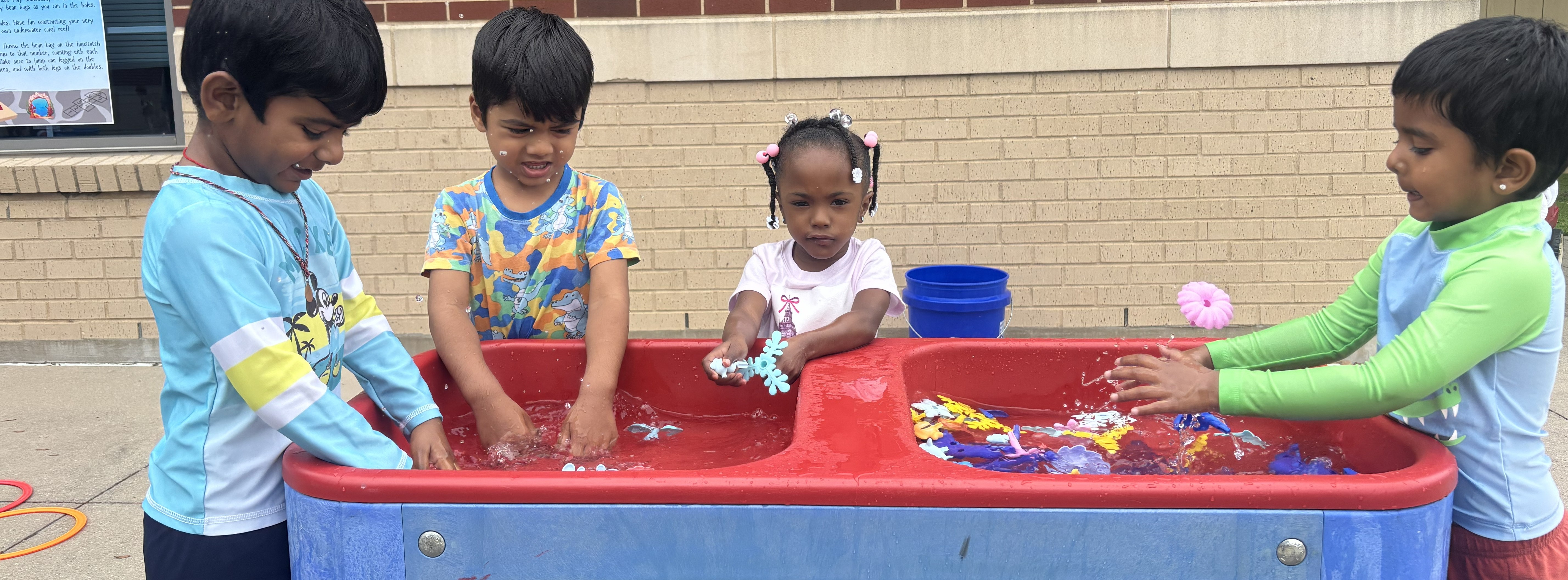 Students standing at a water table building