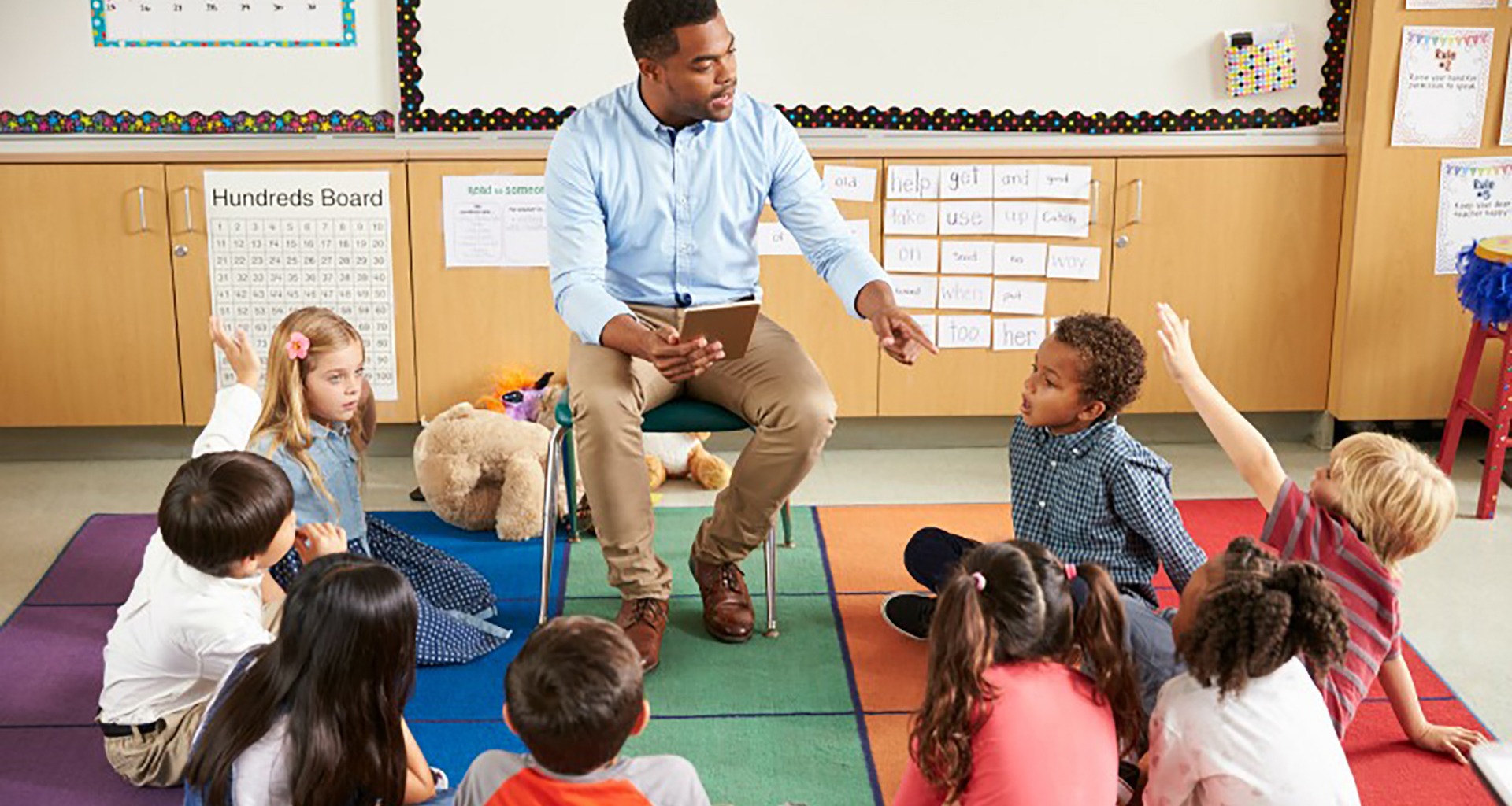 teacher reading to circle of students