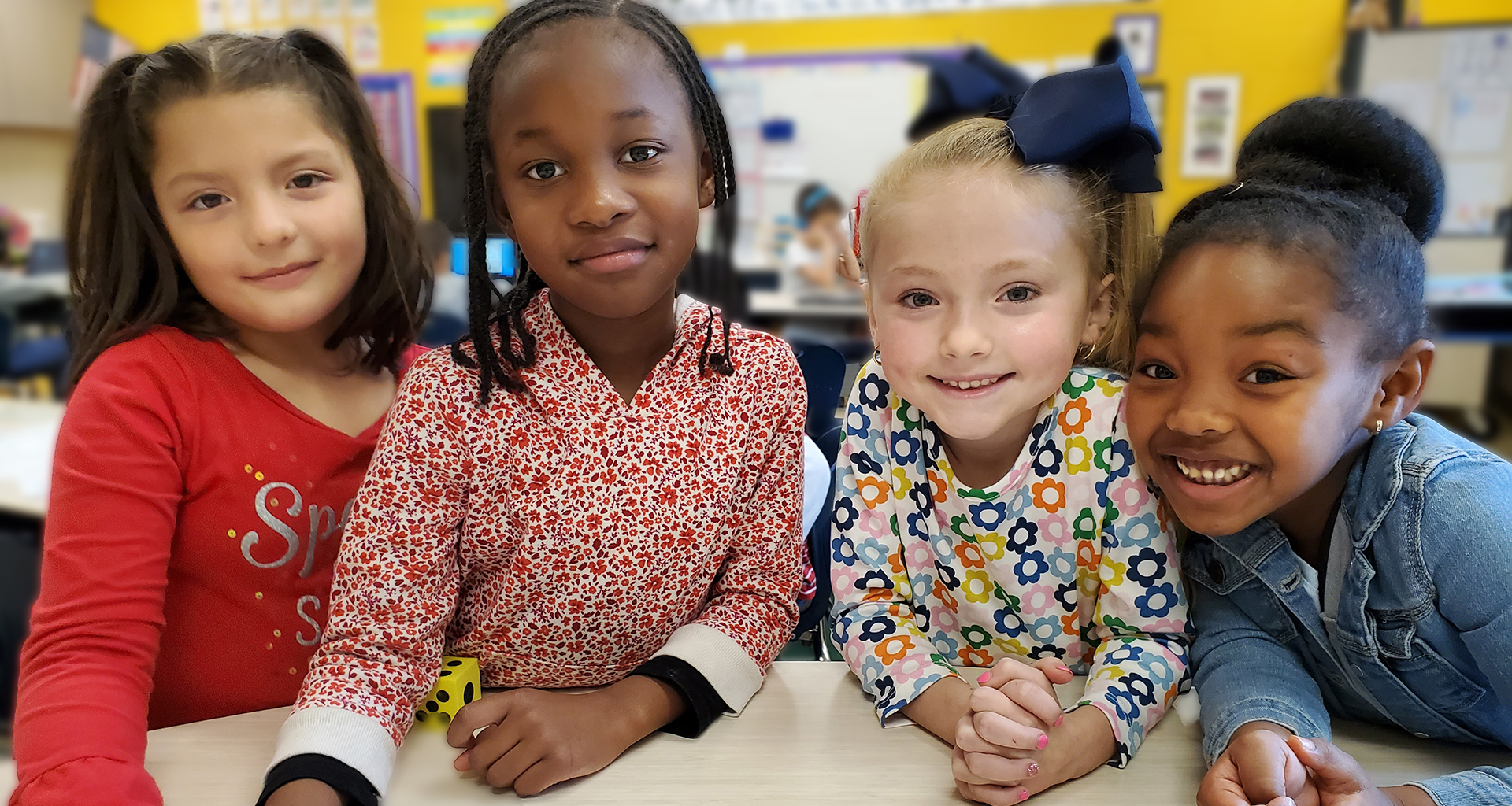 Four students smile for the camera