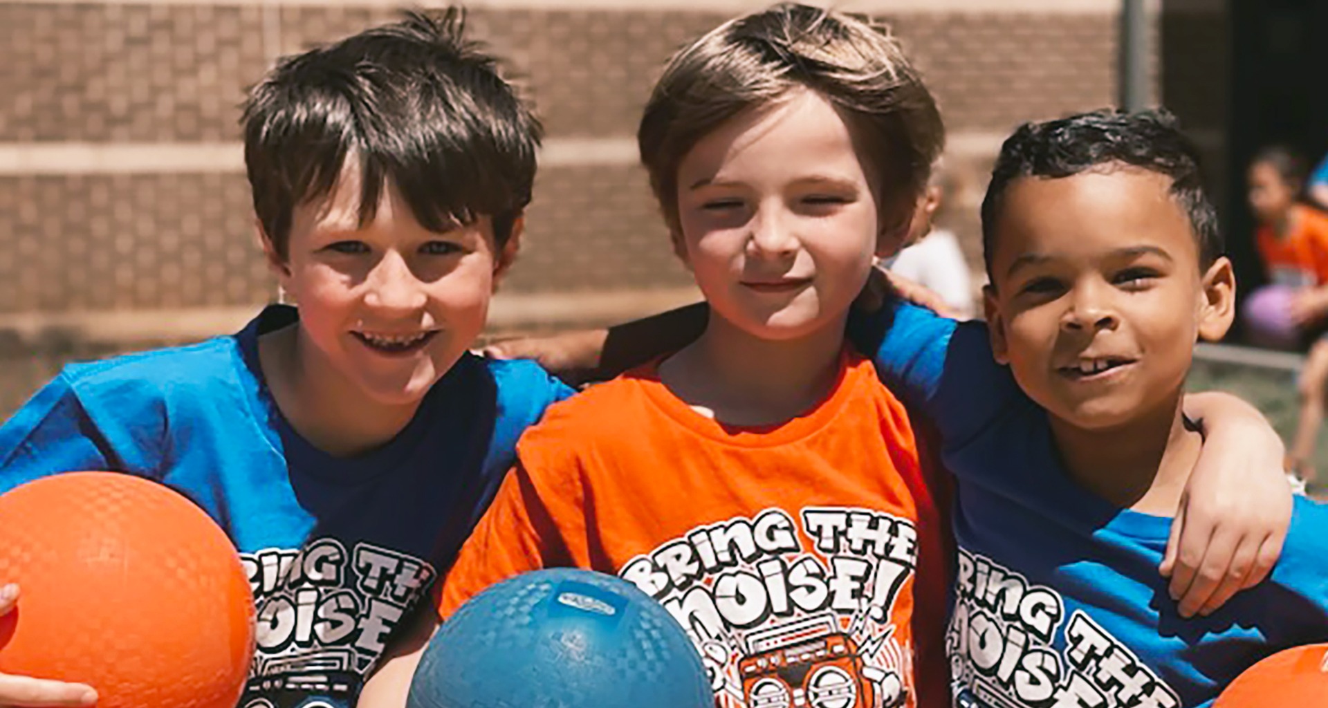 Three boys pose for photo