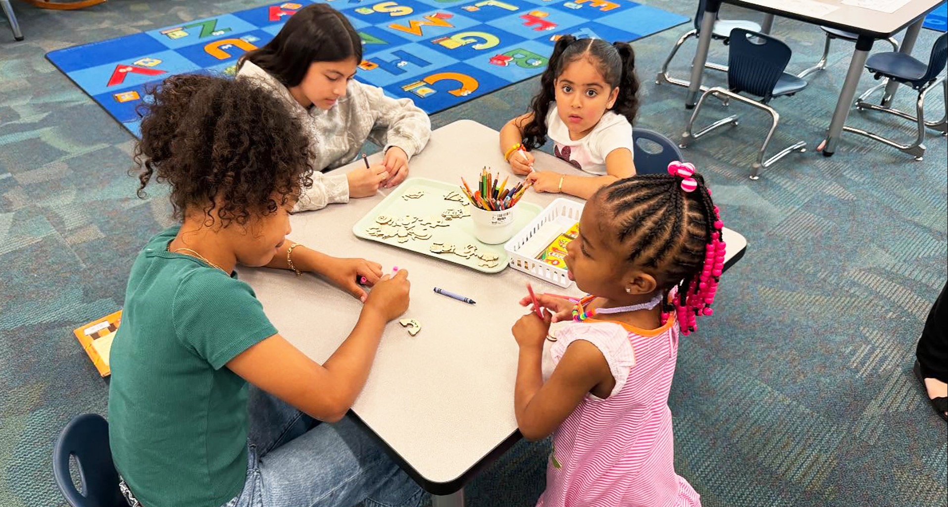 Four students at a table in the library