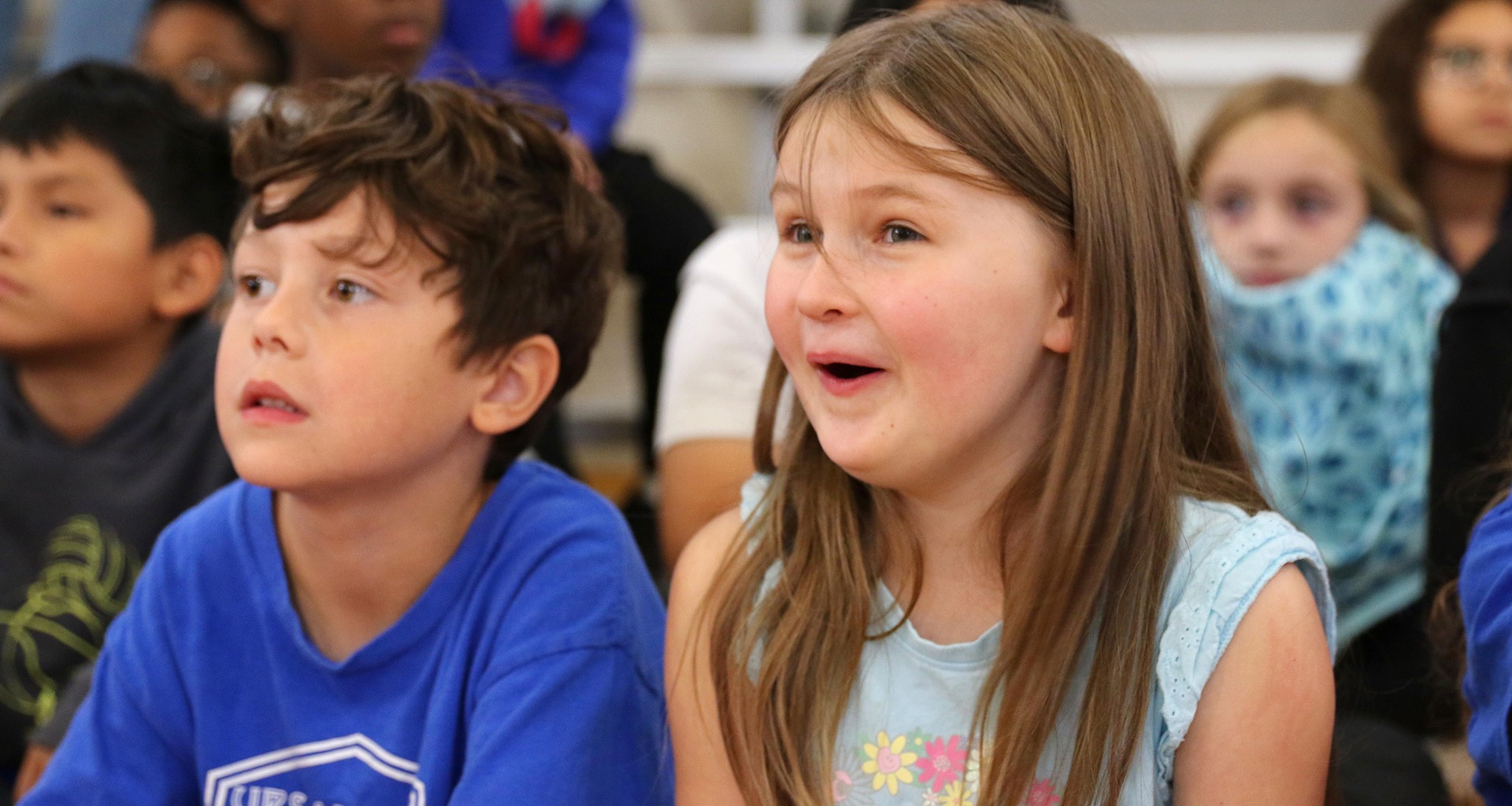 Two students sit in gym