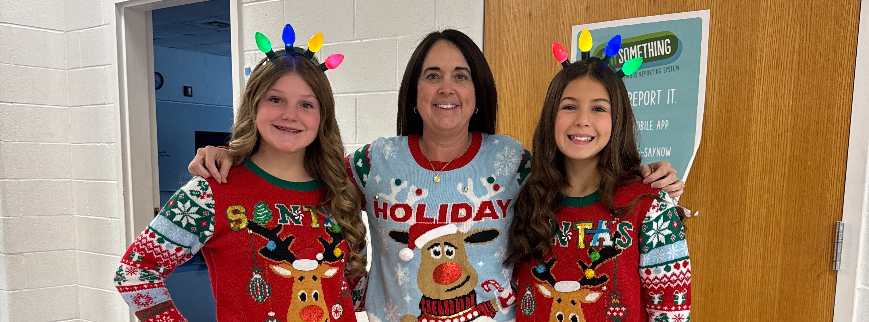 Mrs. Hewett and students dressed up for Ugly Sweater Day.